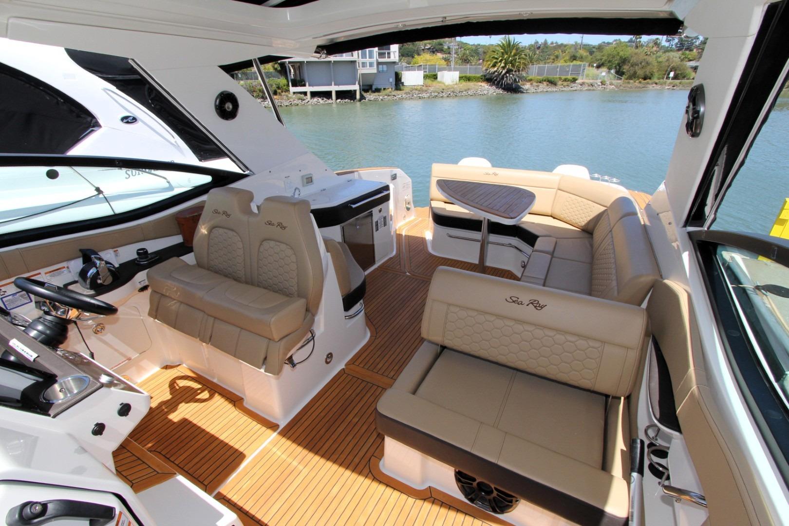 2021 Sea Ray Sundancer 320 Outboard interior with luxurious seating and scenic water view.