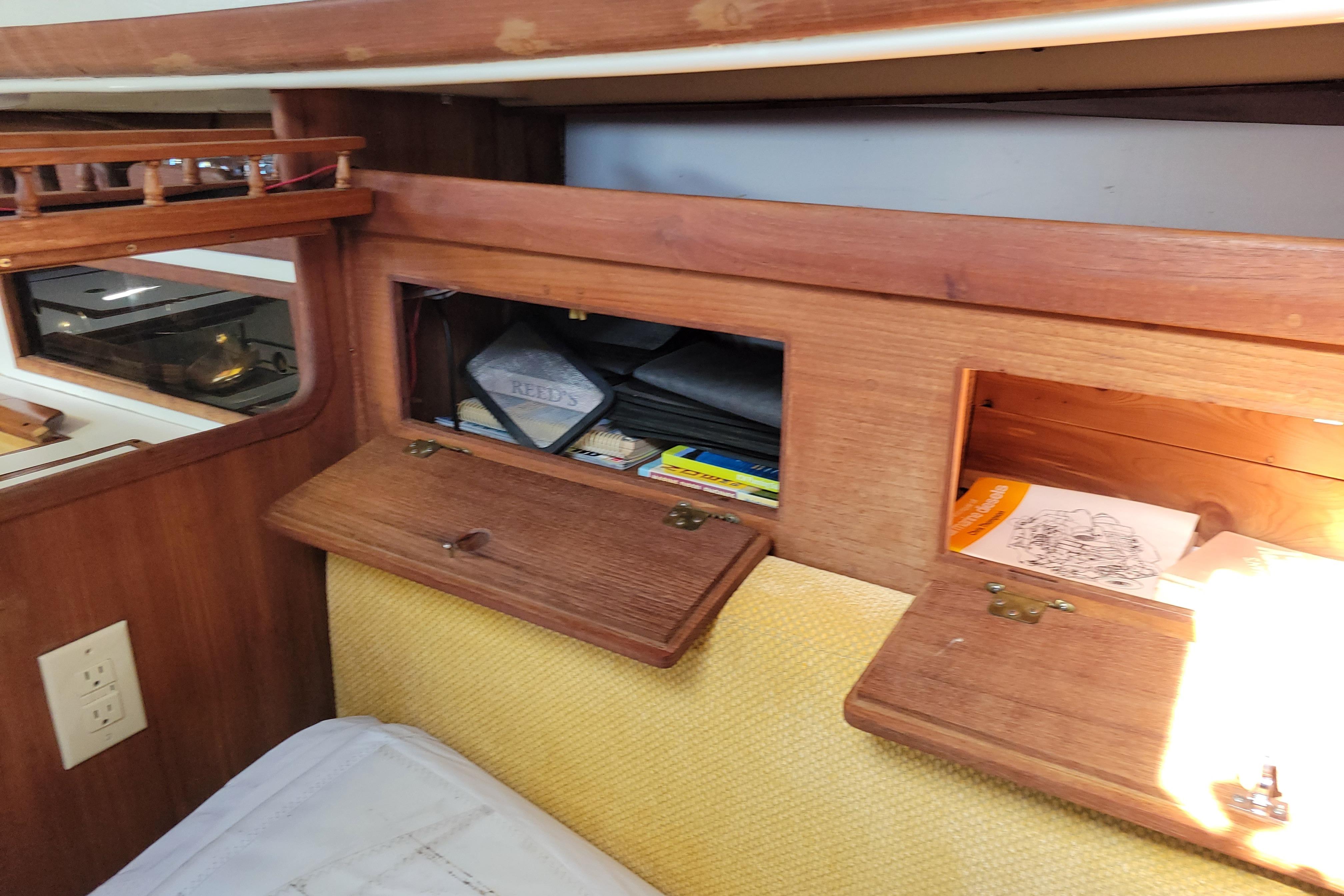 Interior storage compartments on a 1981 Sea Sprite 34 sailboat, featuring wooden cabinetry.