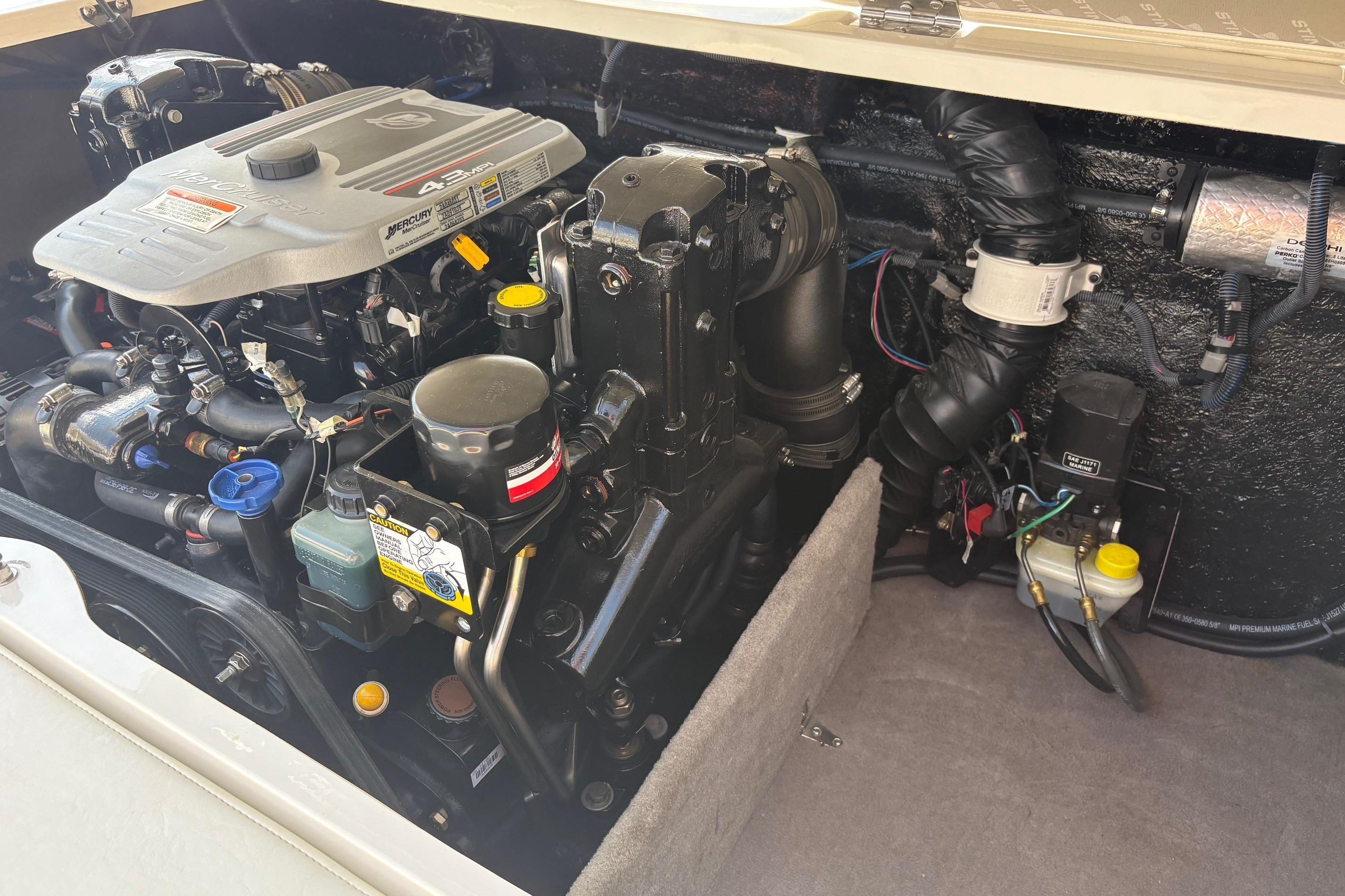 Engine compartment of a 2013 Stingray 198 LX boat, featuring a Mercury 4.3L motor.