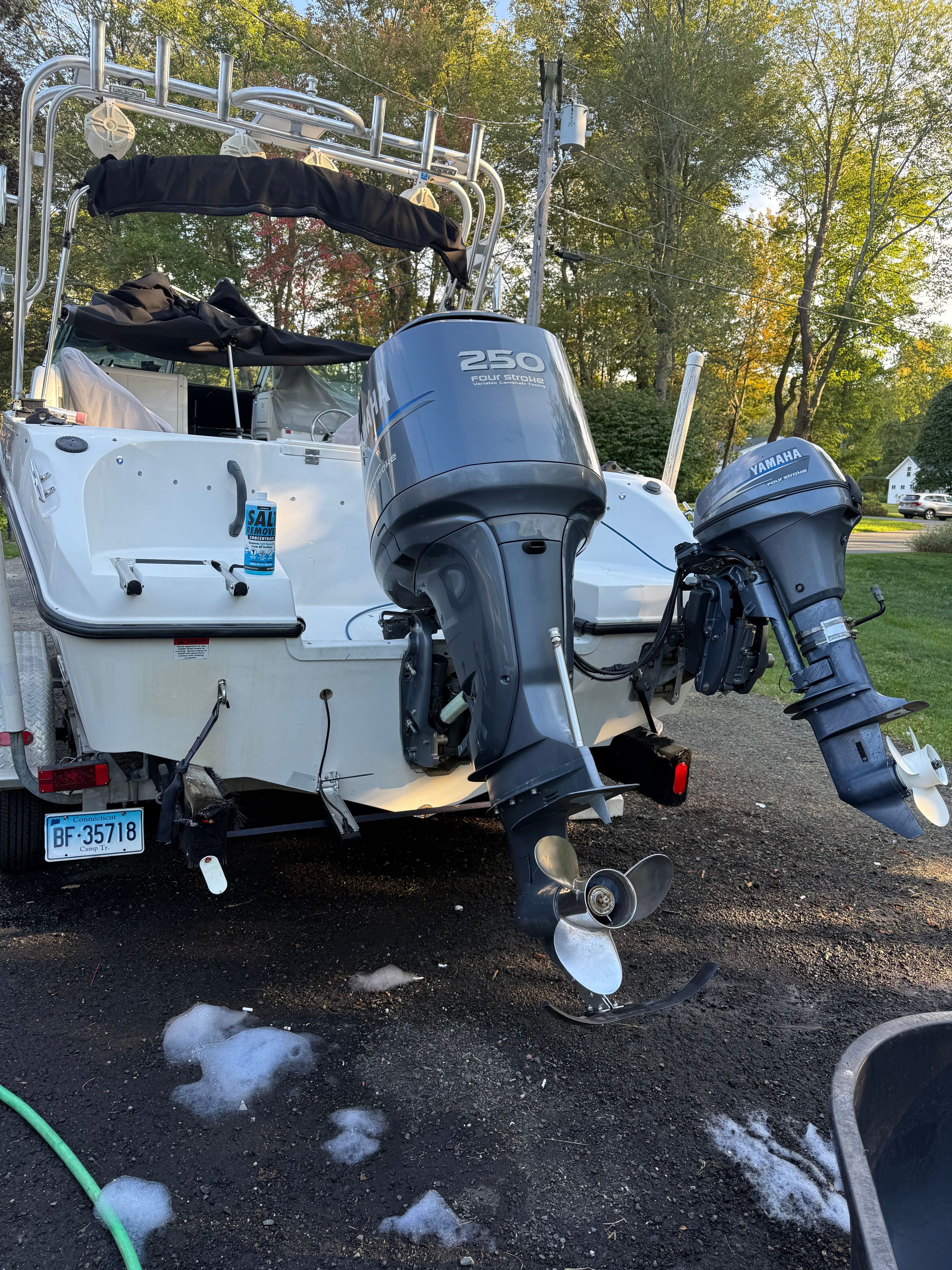 A 2002 Seaswirl Striper 2101 DC with two outboard motors on a trailer.