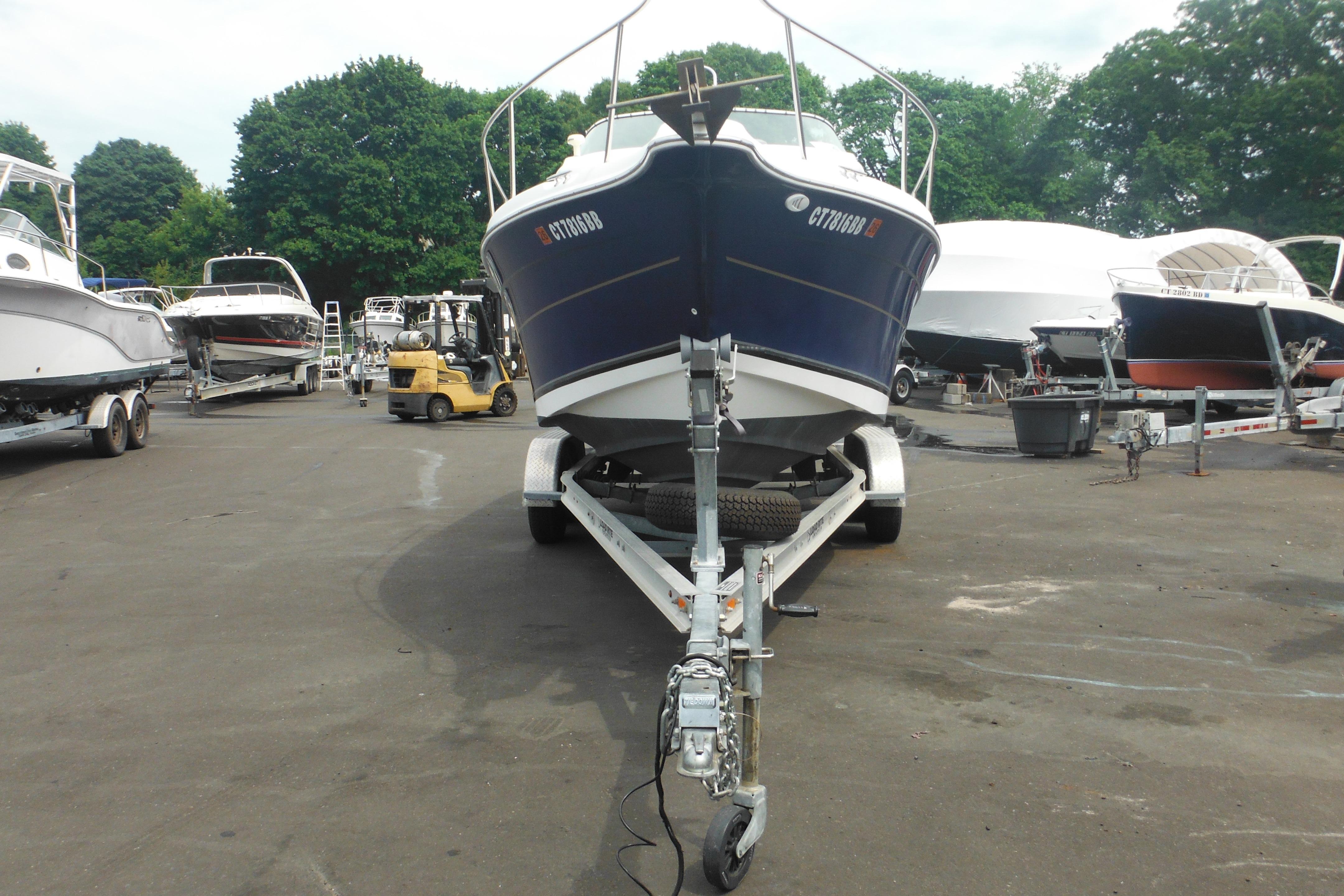 2005 Seaswirl Striper 2101 Walkaround O/B on trailer in a boatyard.