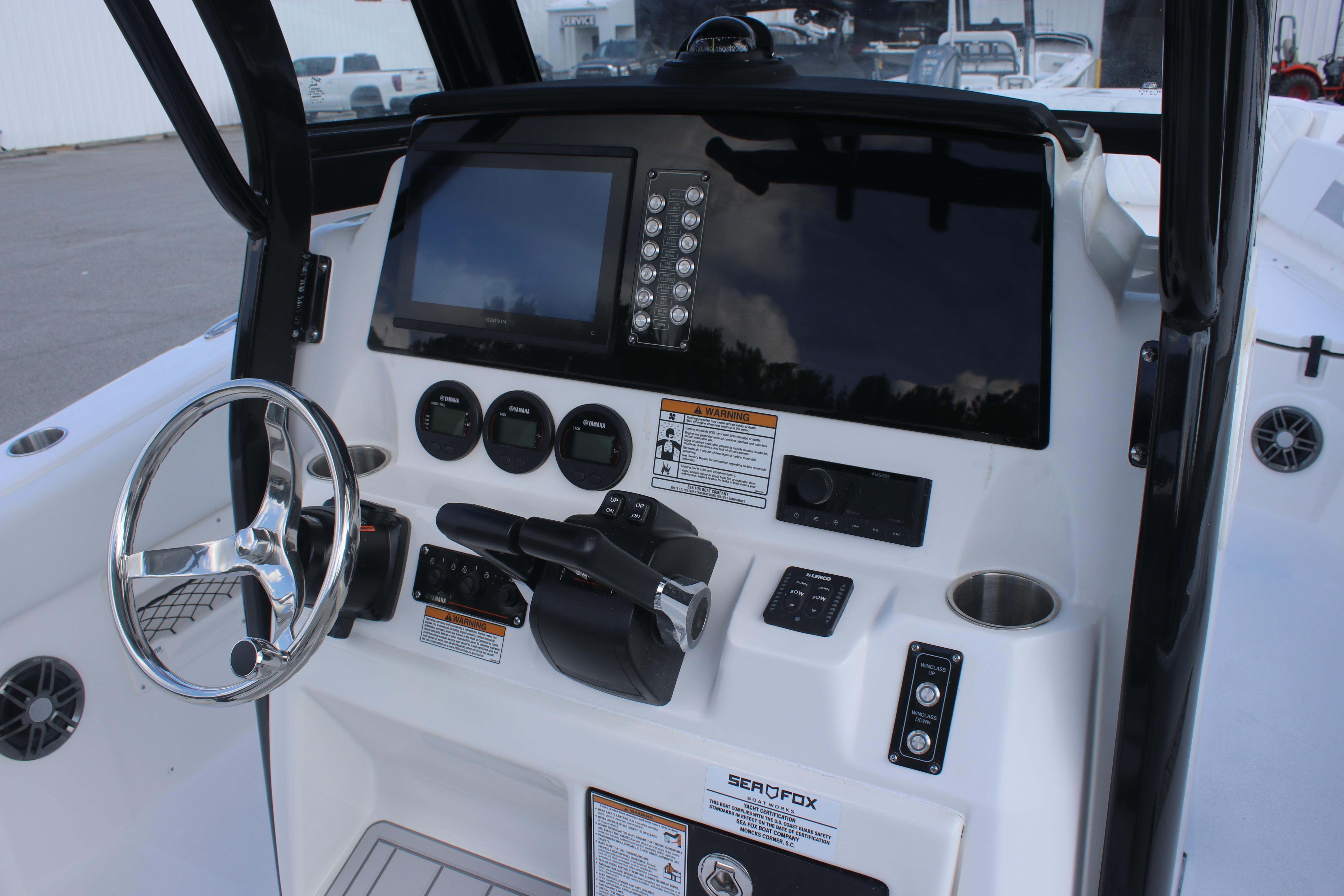 2026 Sea Fox 268 Commander boat dashboard with steering wheel and control panel.
