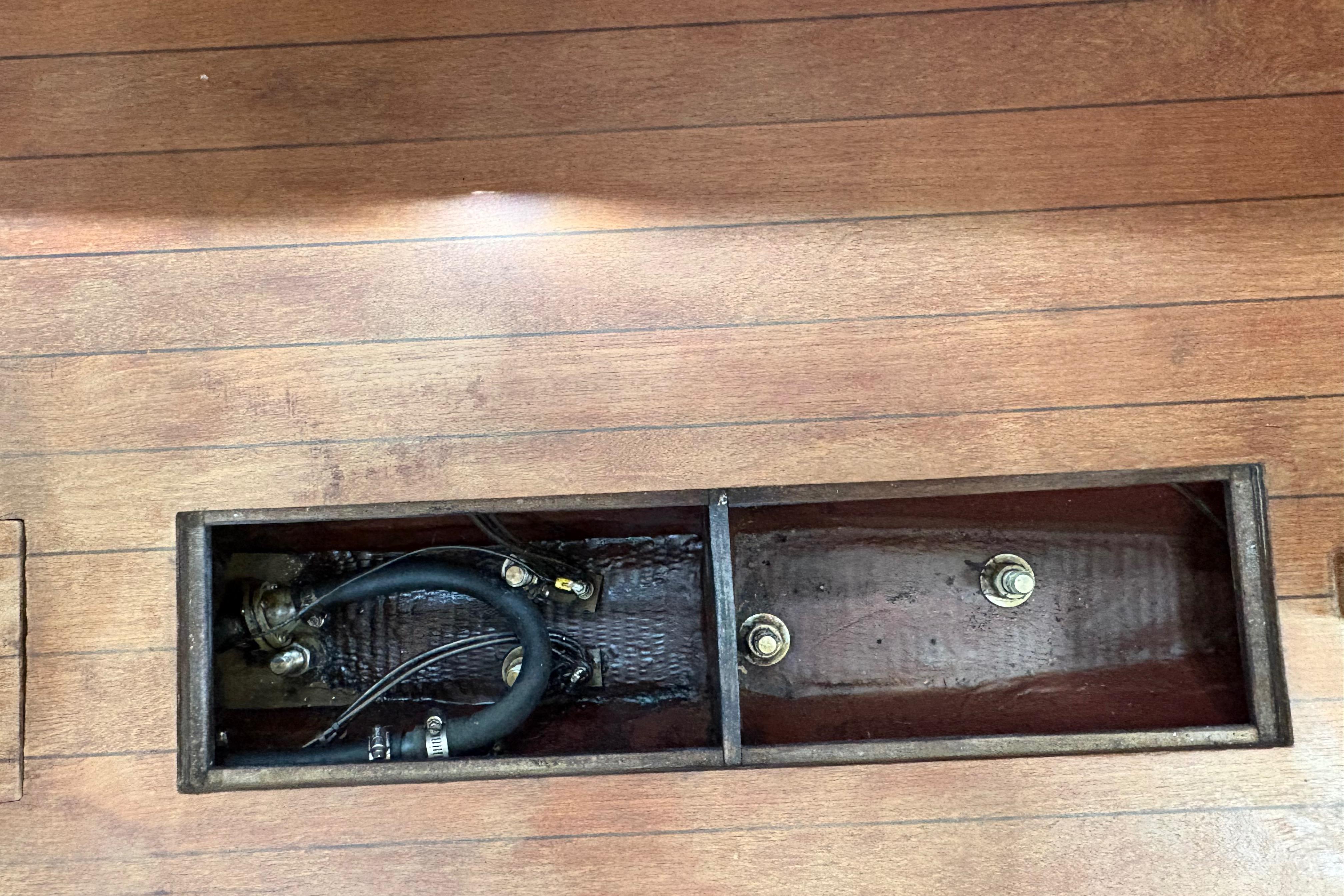 Wooden floor compartment of 1981 Sabre 31 sailboat, showing internal wiring and components.