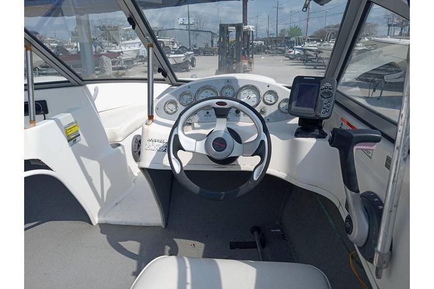 2008 Bayliner 175 boat dashboard with steering wheel and gauges, featuring a GPS device.