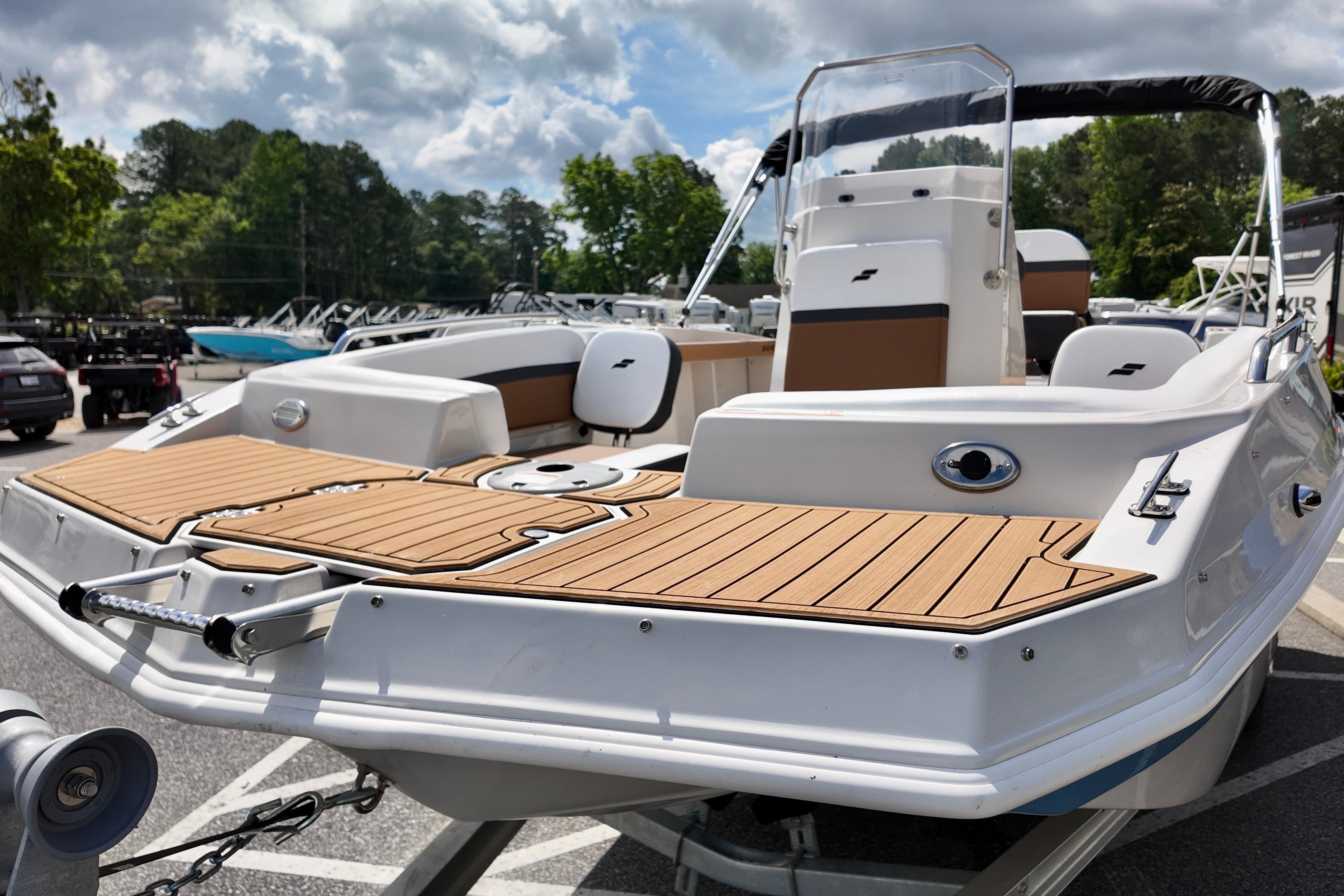 2026 Starcraft SVX 191 OB CC boat with sleek deck design, parked outdoors.