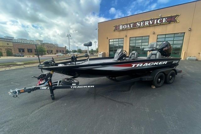 2026 Tracker Savage 215 boat on trailer outside a boat service center.