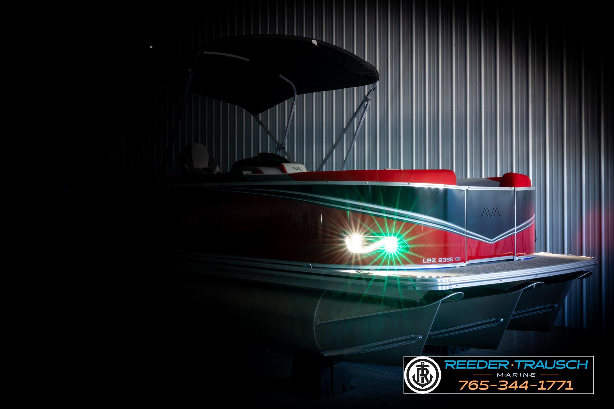 2026 Avalon LSZ QL pontoon boat with illuminated lights in a dimly lit setting.