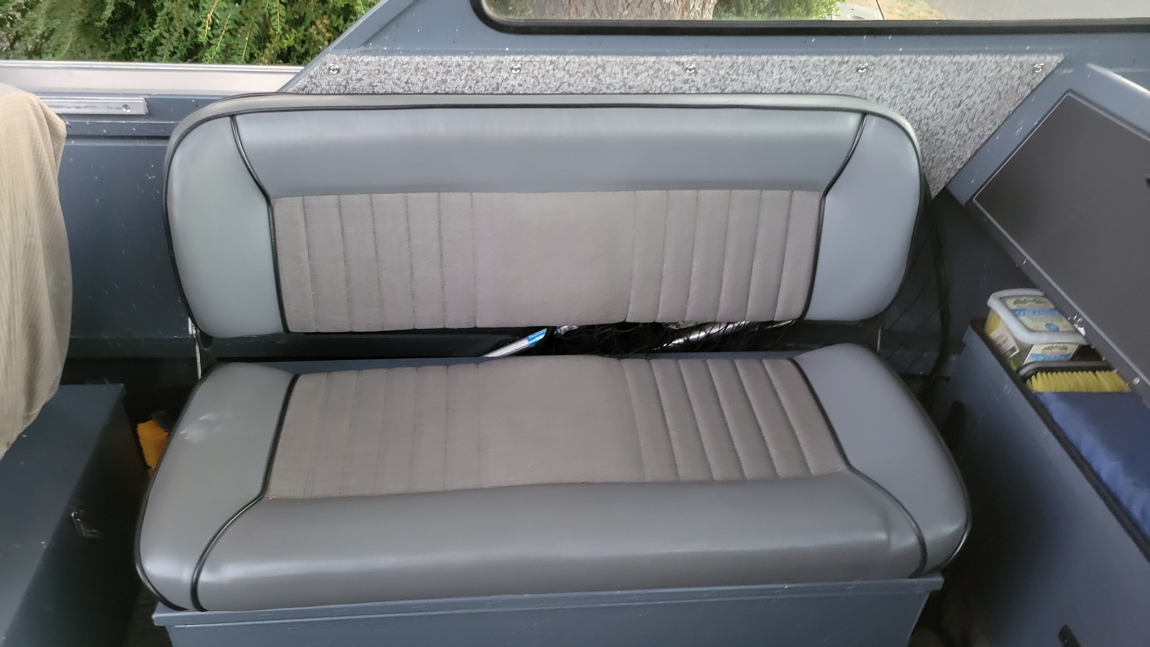 Interior view of a 2015 Alumaweld Formula Vee Outboard 24 with a gray bench seat.