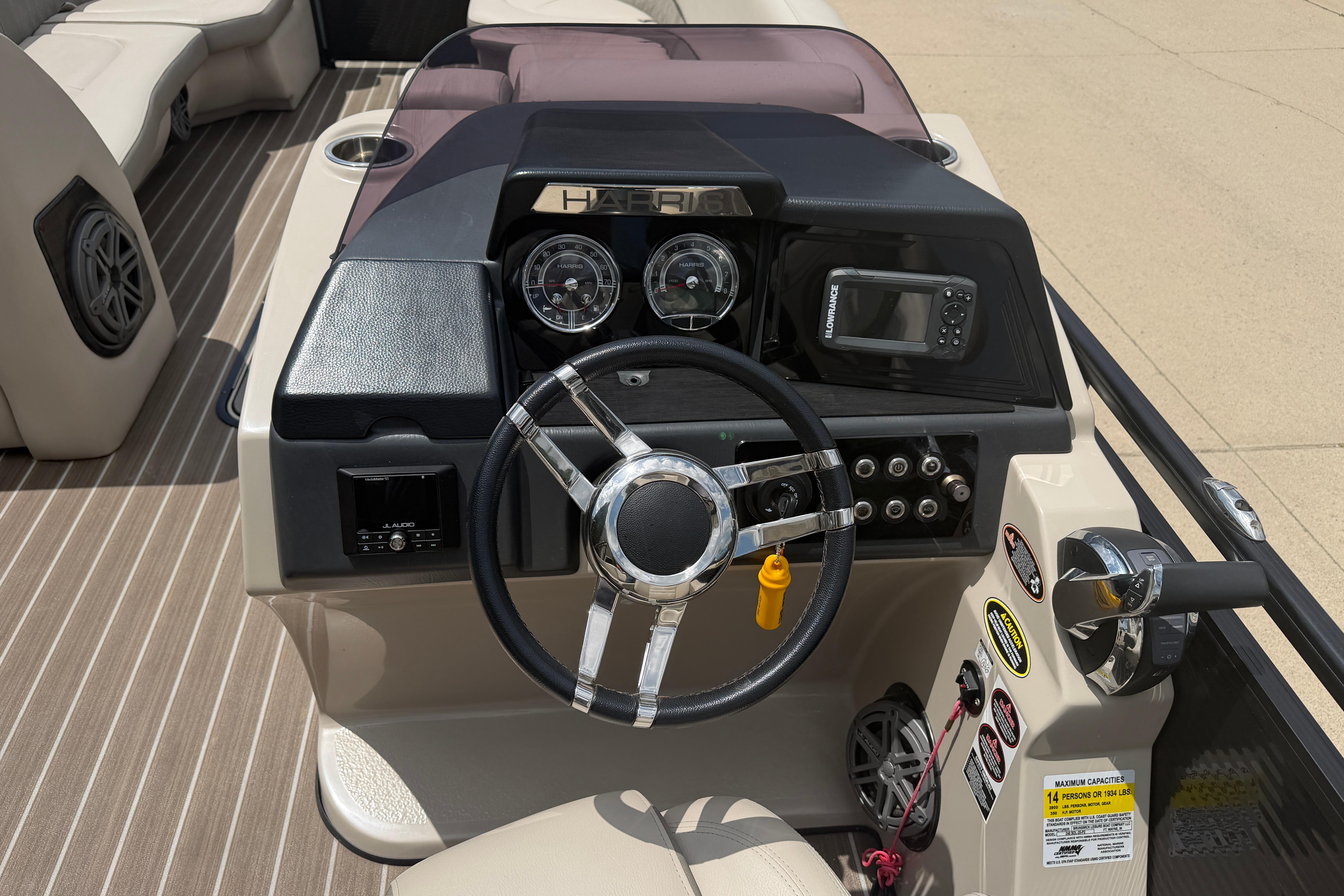 2019 Harris Solstice 240 boat dashboard with steering wheel, gauges, and control panel.