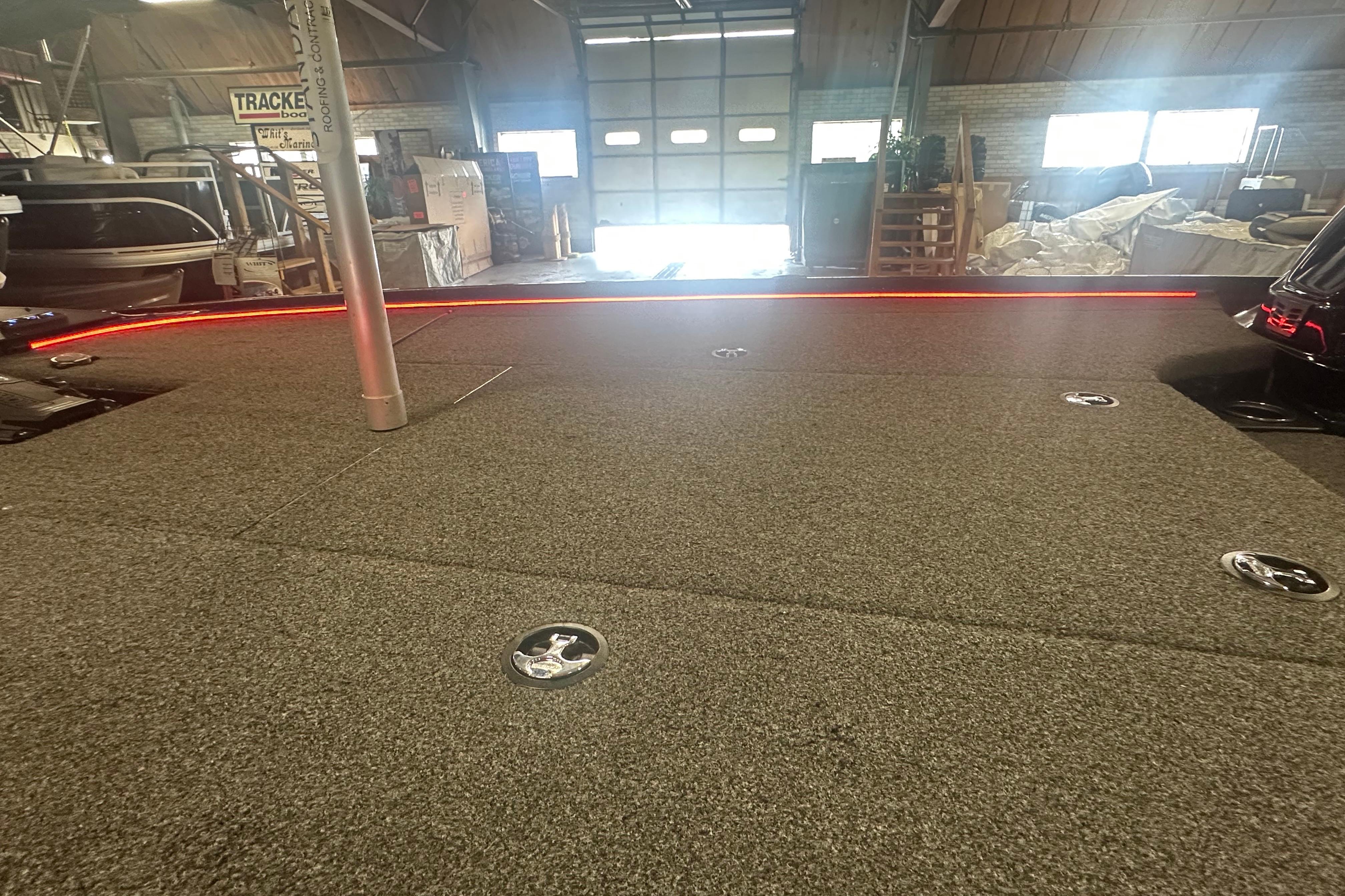 Carpeted deck of a 2022 Nitro Z20 Pro boat in a workshop setting.
