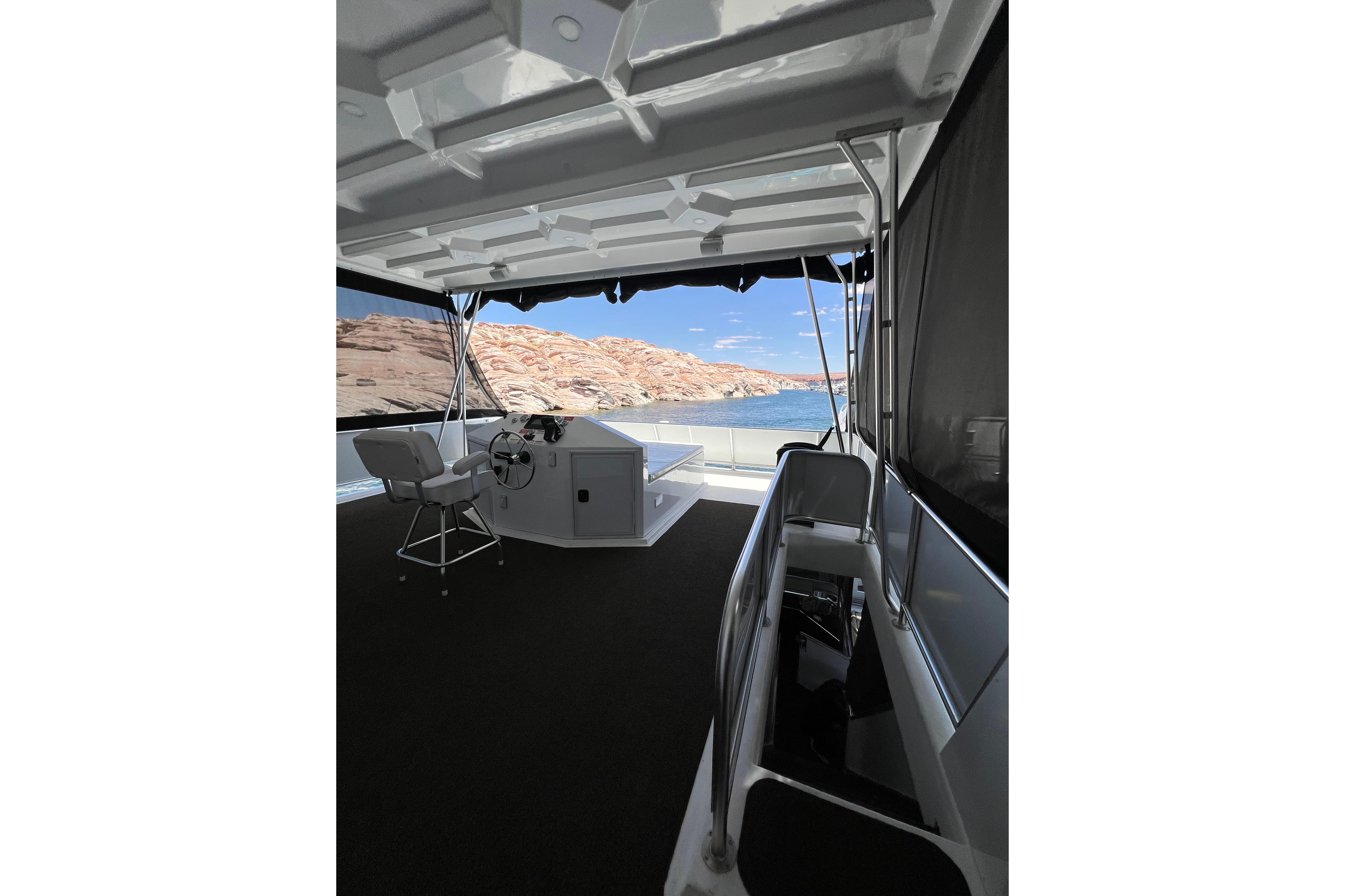 Upper deck of 2025 Sumerset Excellence houseboat with scenic lake view.