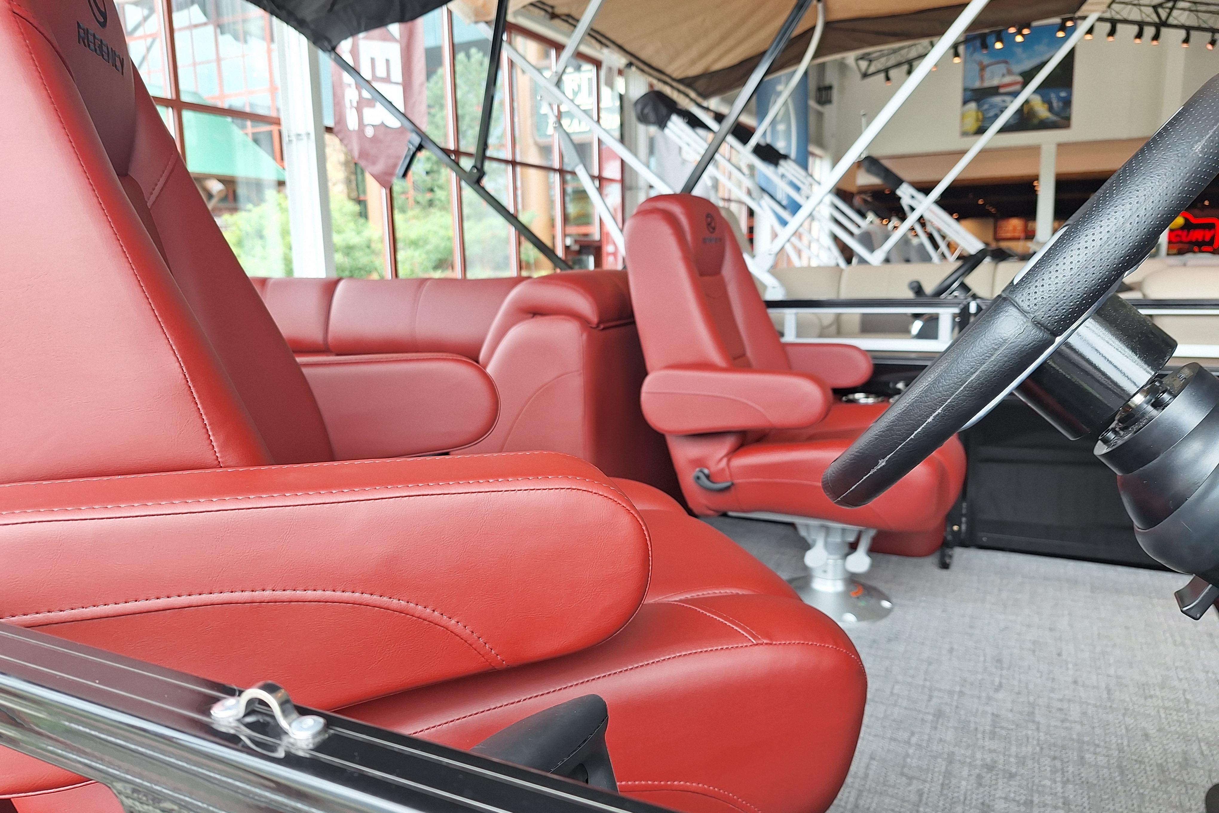 Luxurious red leather seating in 2026 Regency 230 DL boat interior.
