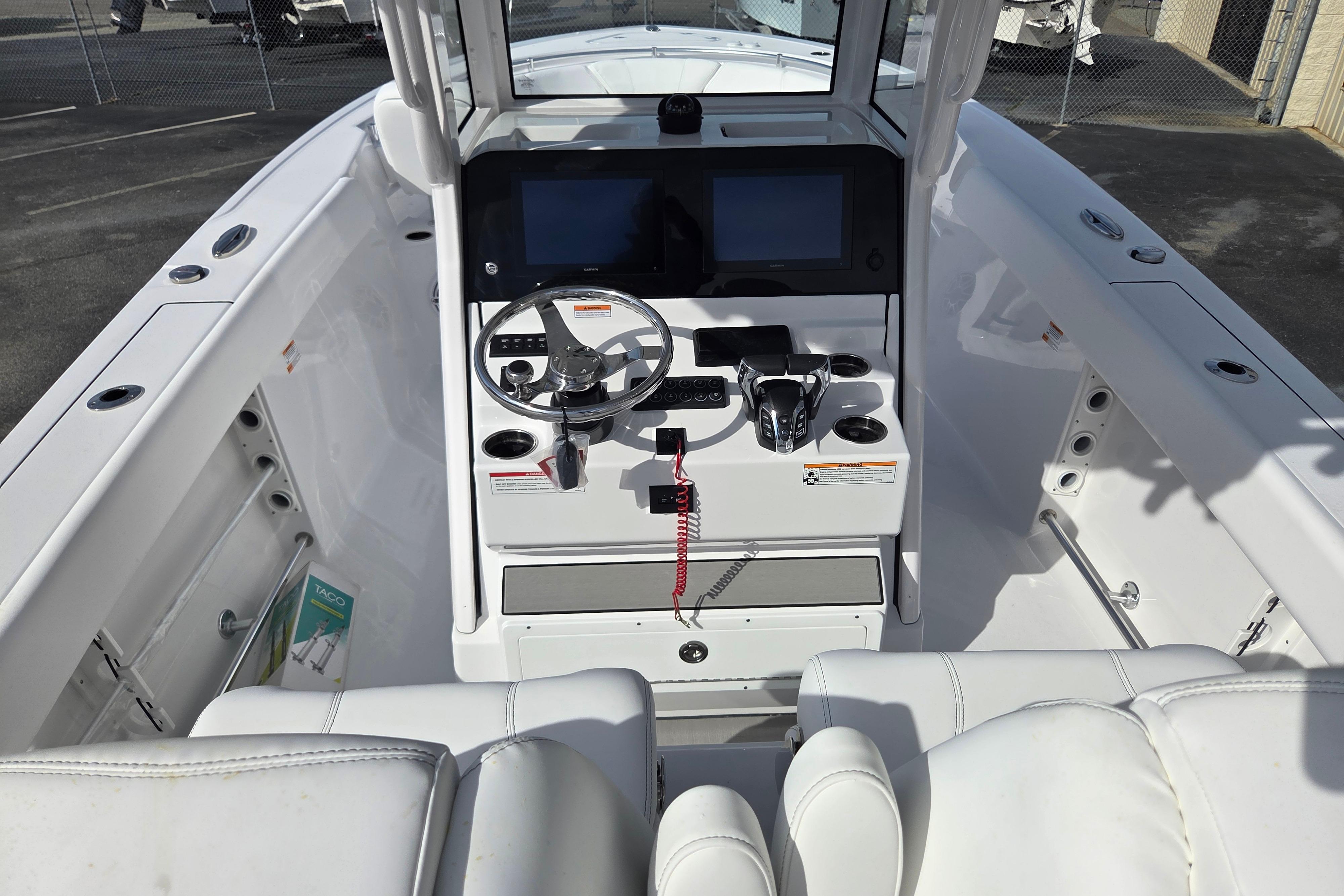 2026 Sportsman Heritage 261 Center Console boat interior with steering wheel and controls.