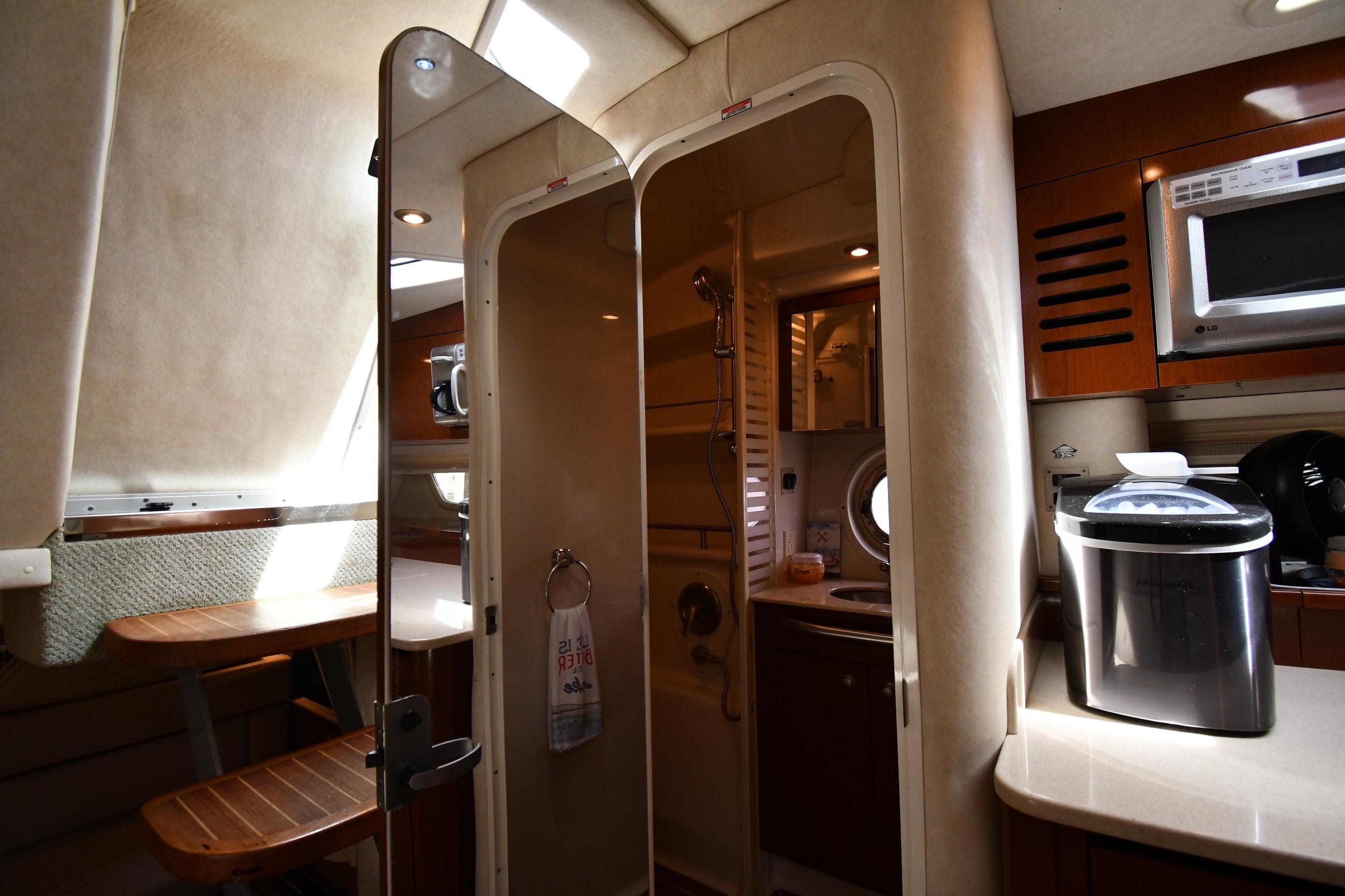 Interior of 2008 Sea Ray Sundancer 350 yacht, featuring kitchenette and bathroom area.