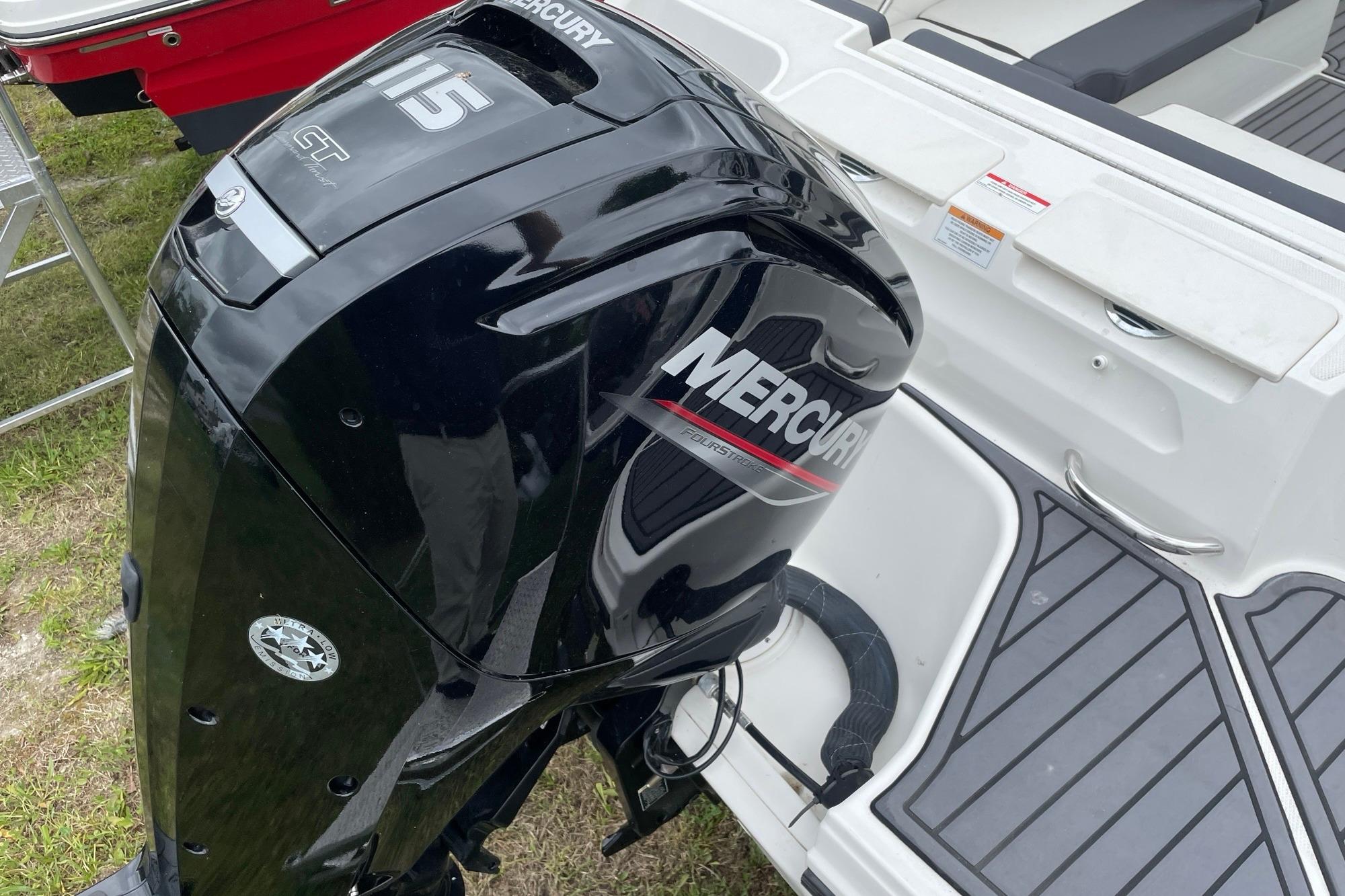 2023 Bayliner VR4 Bowrider OB with Mercury outboard motor, docked on grass.