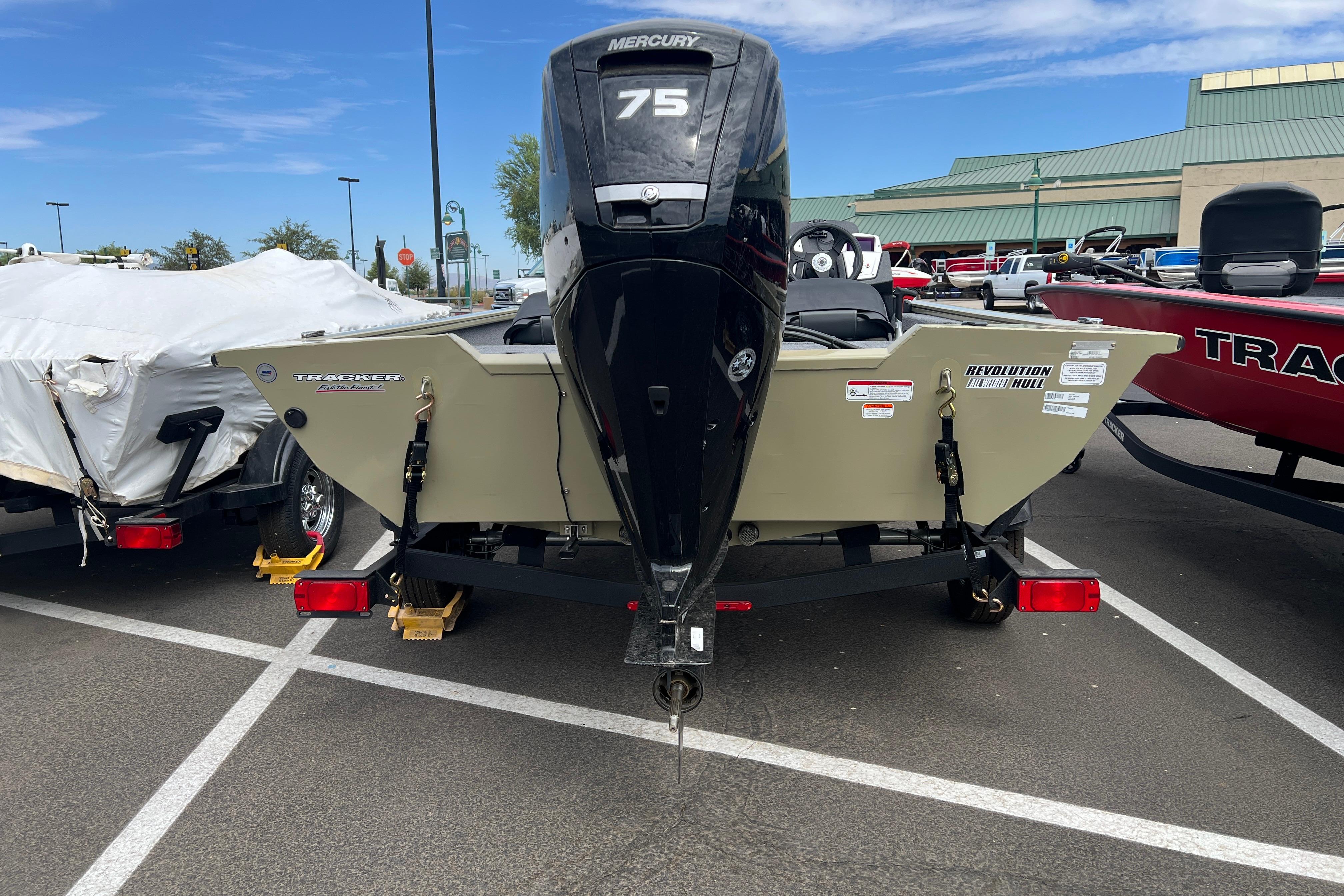 2026 Tracker Pro Team 175 Crappie Edition boat with Mercury 75 engine in parking lot.