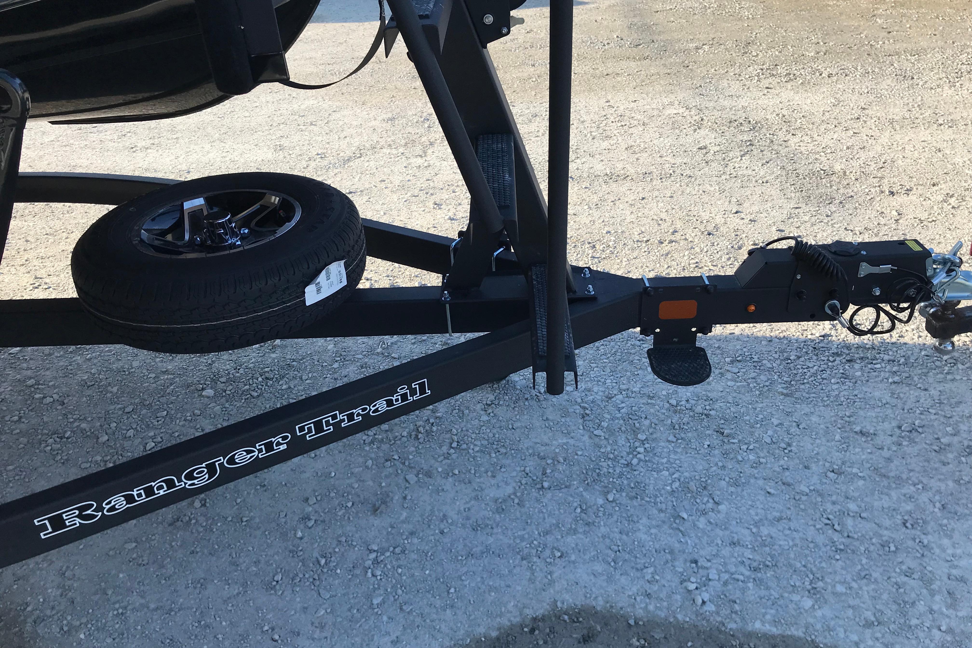 Trailer hitch of 2026 Ranger Reata 220FC boat on gravel surface.