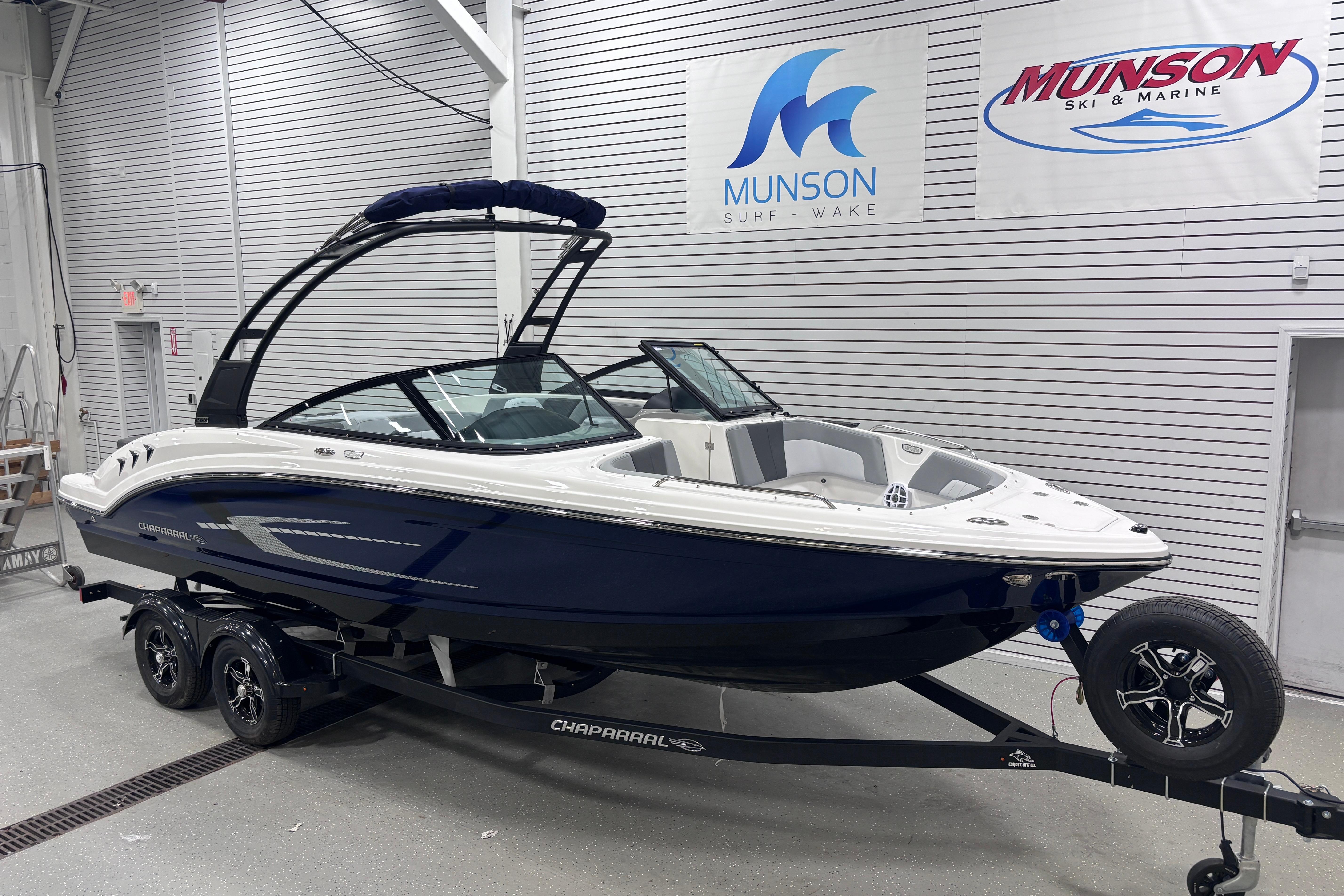 2026 Chaparral 23 SSi boat in showroom, featuring sleek design and modern features.