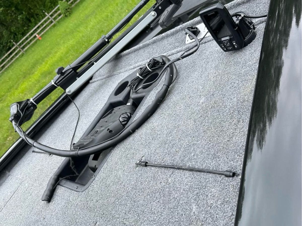 The image shows the deck of a 2022 Bass Tracker 195TXW with fishing equipment.