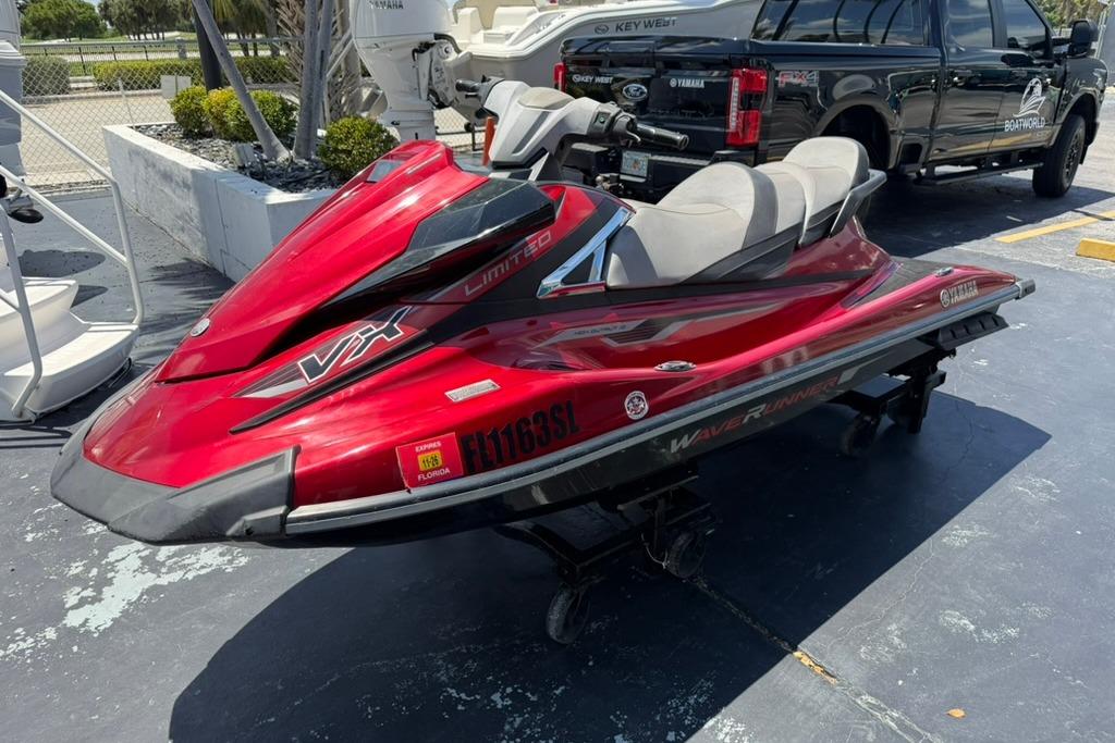 2019 Yamaha VX Limited jet ski in vibrant red, parked outdoors on a sunny day.