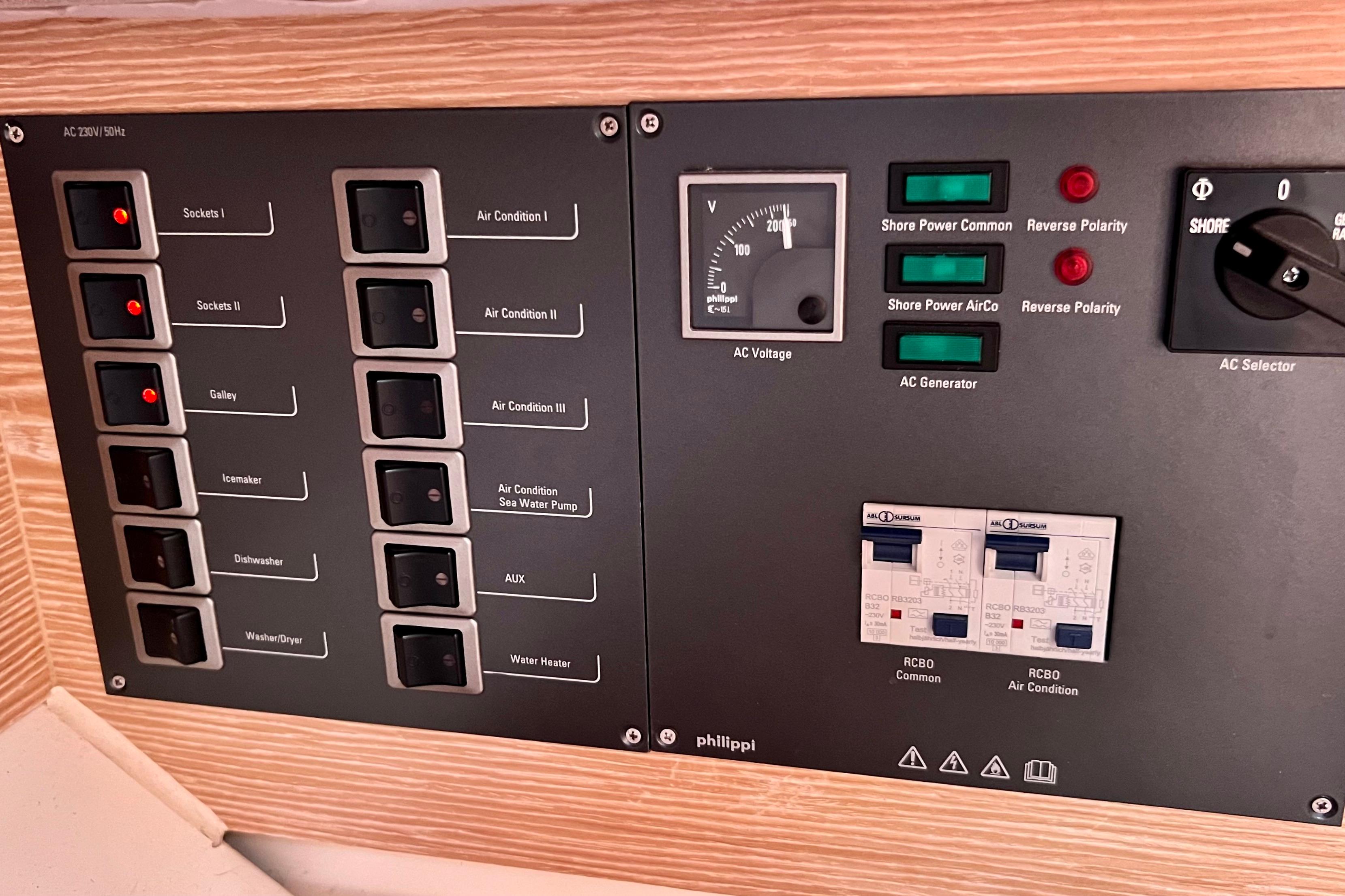 Electrical control panel on a 2016 Hanse 455 yacht, featuring switches and voltage indicators.