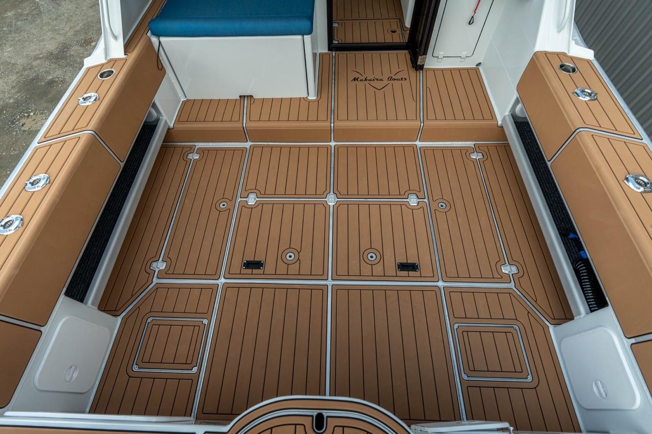 Makaira Gen 3 36 boat deck, 2025 model, featuring tan and white cushioned seating.