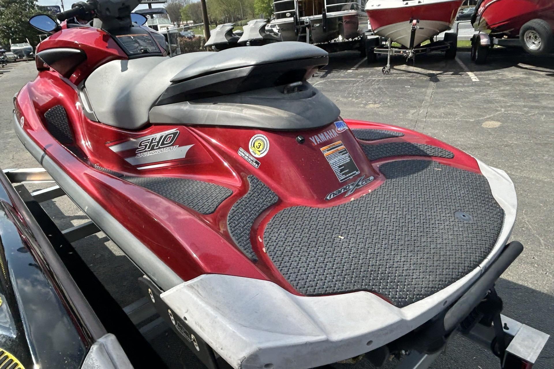 2011 Yamaha WaveRunner FZS in red, parked on a trailer in a lot.