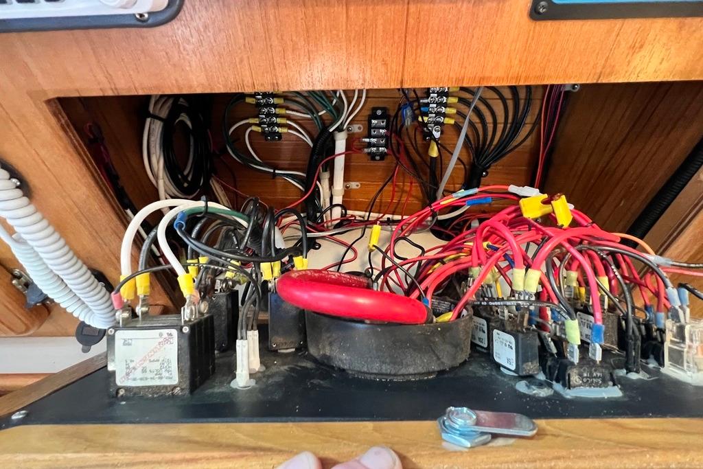 Electrical wiring panel inside a 1999 Catalina 36 MkII sailboat, showcasing complex connections.