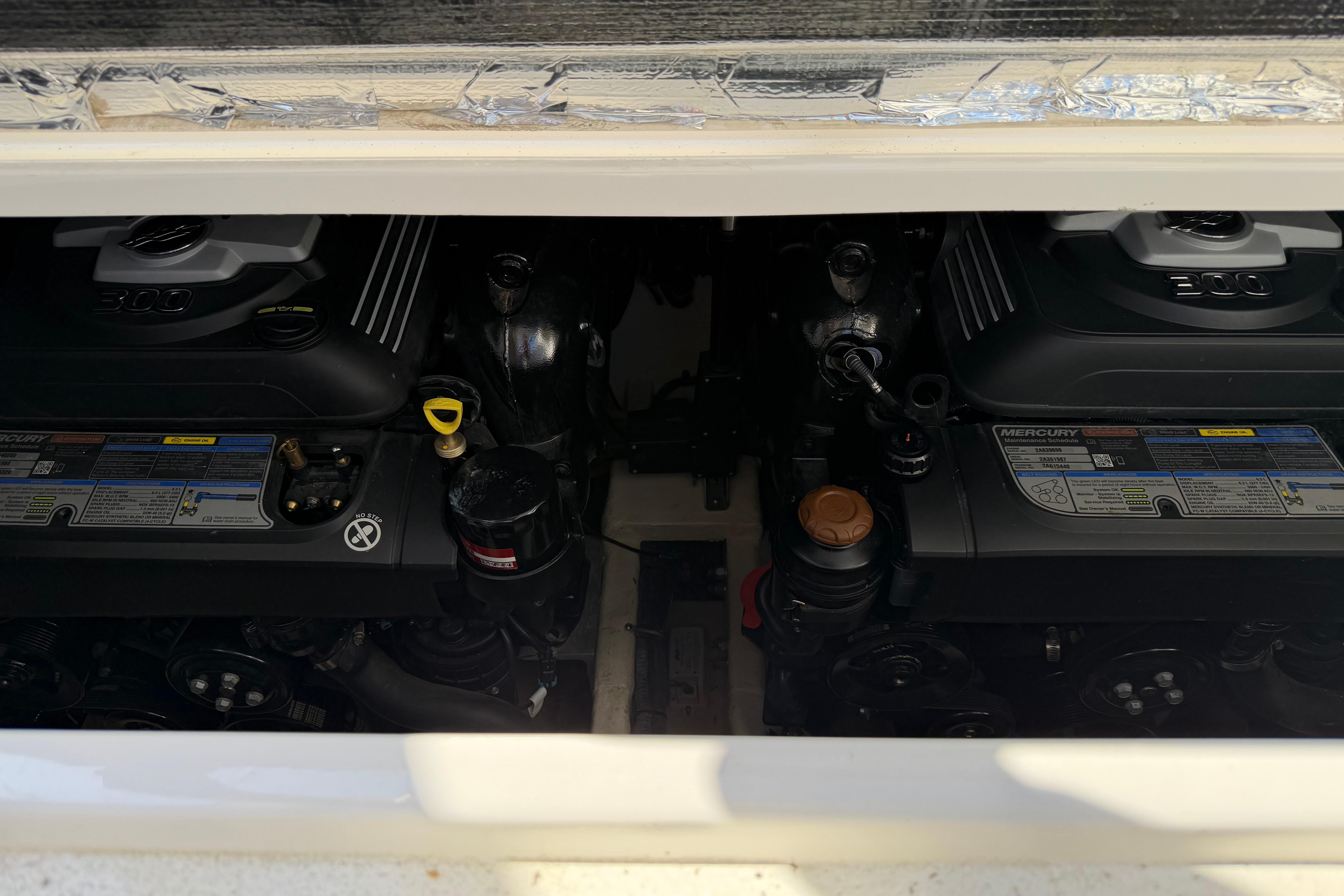 2019 Rinker EX 320 boat engine compartment with dual Mercury engines.