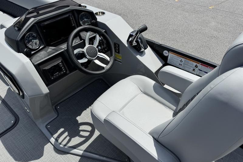 2026 Manitou Encore 25 SL SHP boat cockpit with steering wheel and controls.