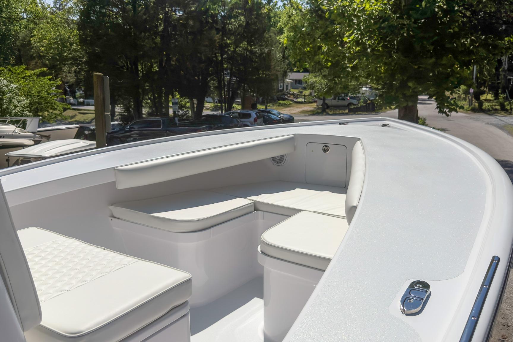 Bow seating area of a 2025 Weaver 25 boat, featuring white cushioned seats.