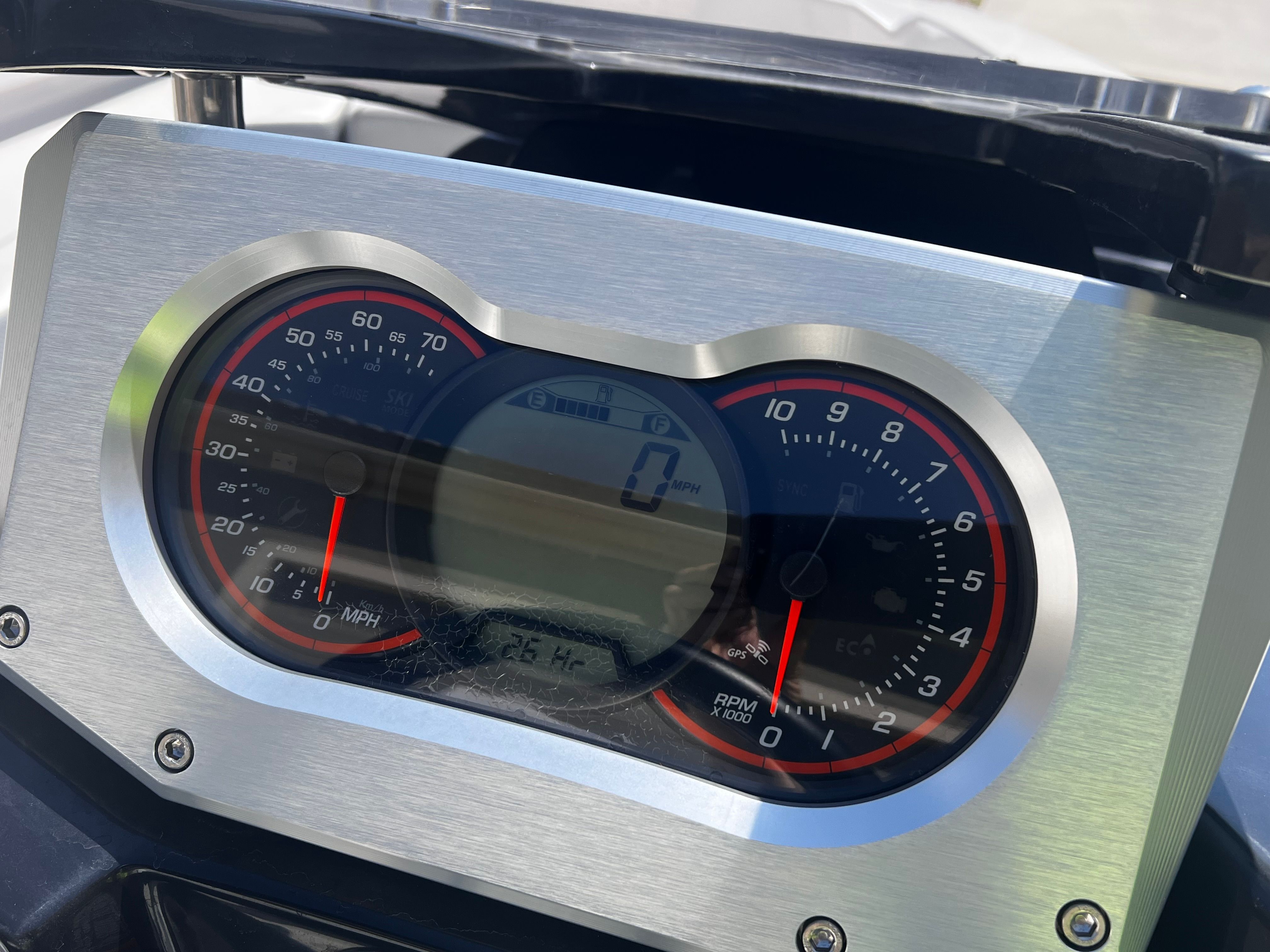 Close-up of a boat's speedometer showing speed and RPM gauges.