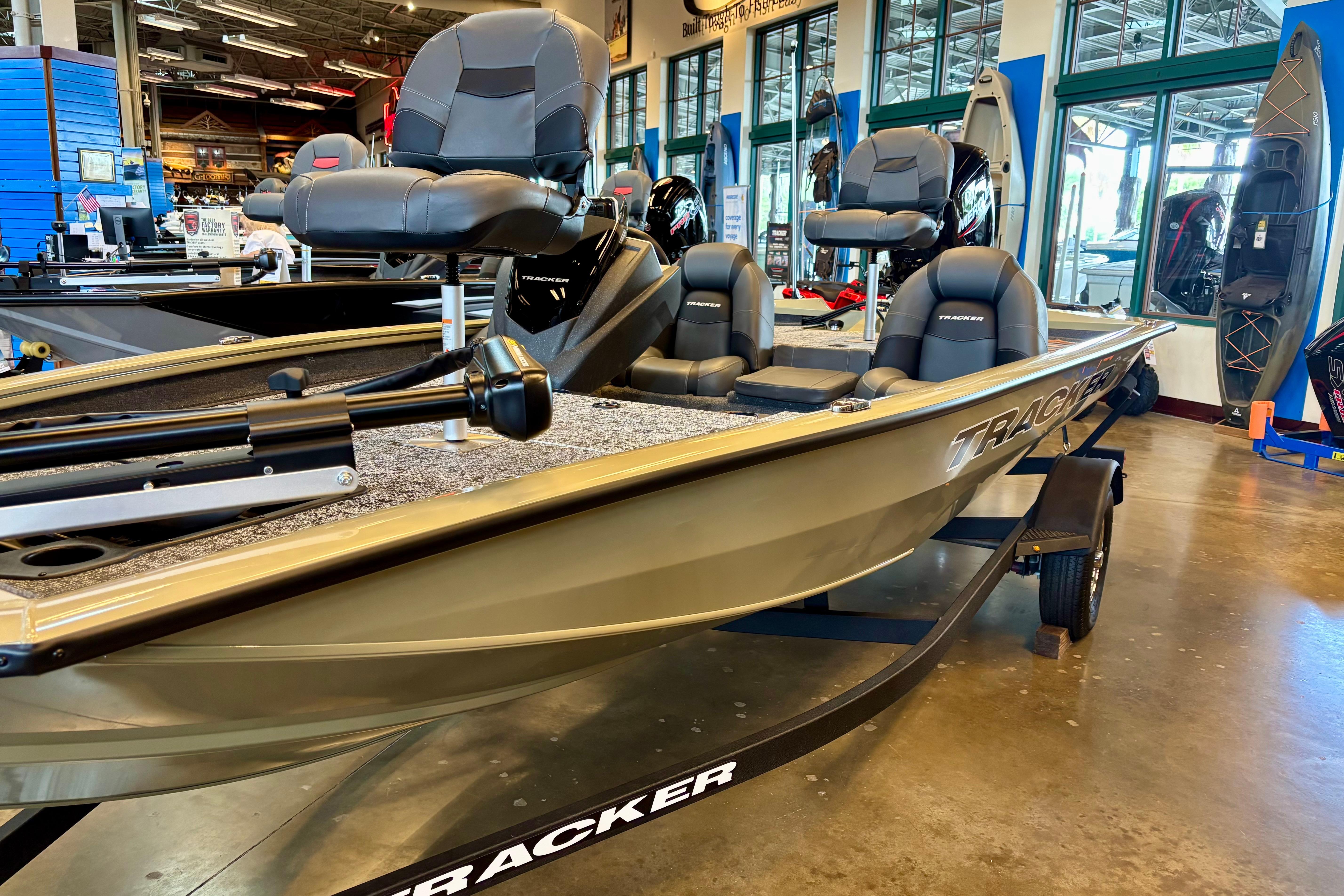 2026 Tracker Pro Team 175 boat displayed in a showroom, featuring comfortable seating.
