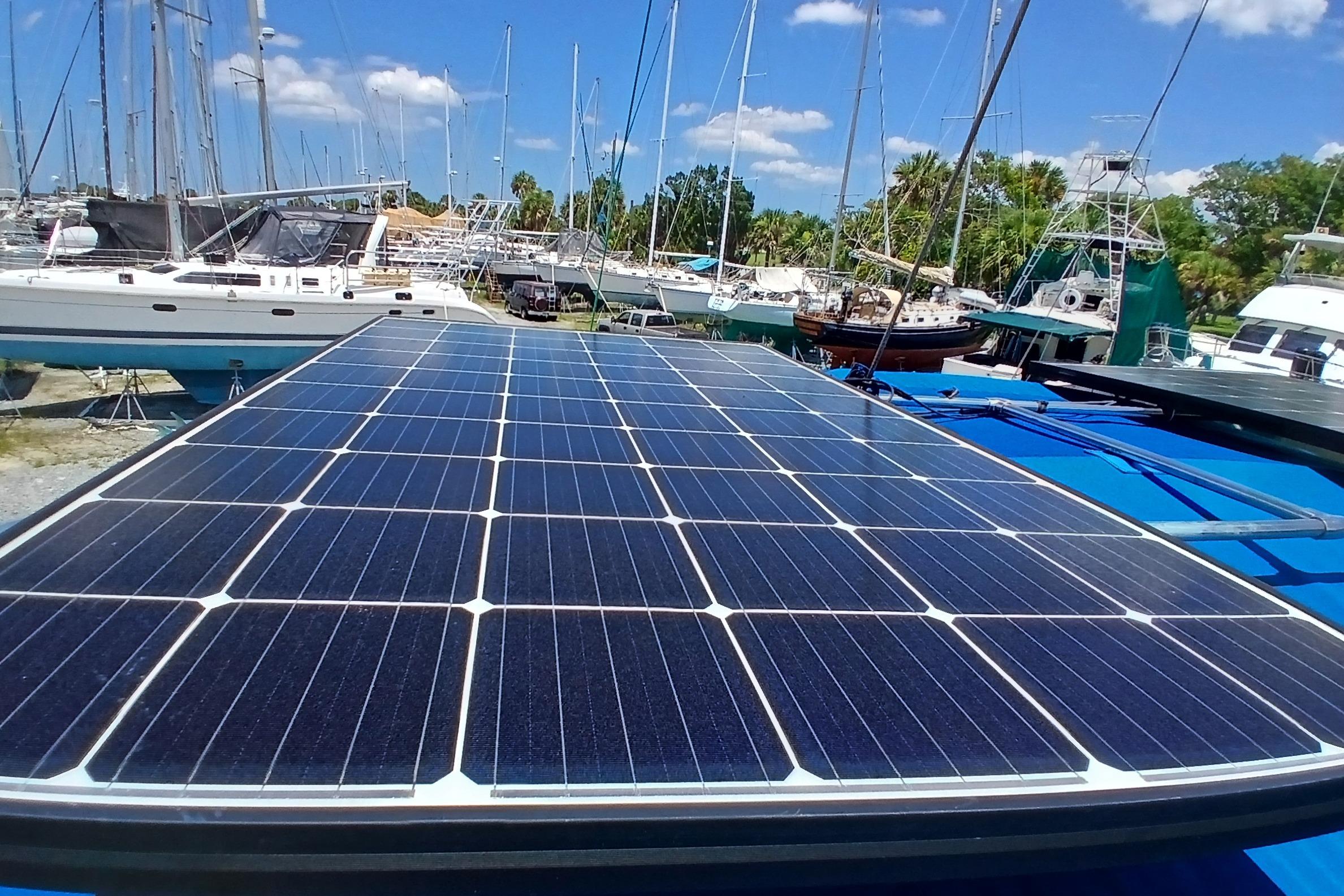 Solar panels on a 1995 Catalina 42 MkII sailboat in a marina under blue skies.