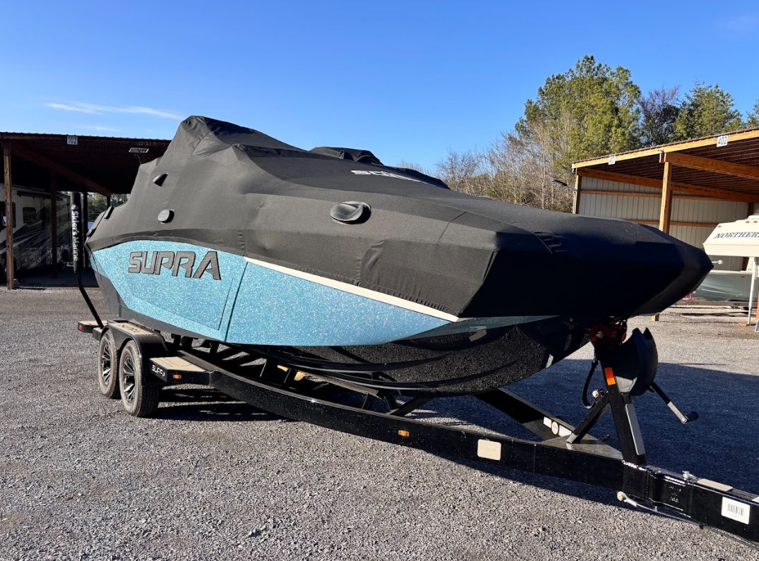 2025 Supra SA 450 boat with cover on trailer.