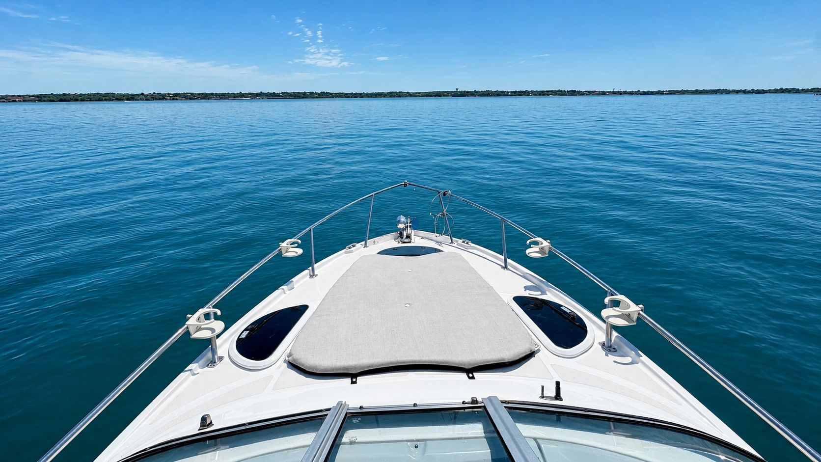 The 2020 Regal 28 Express cruising on calm water under a clear sky.
