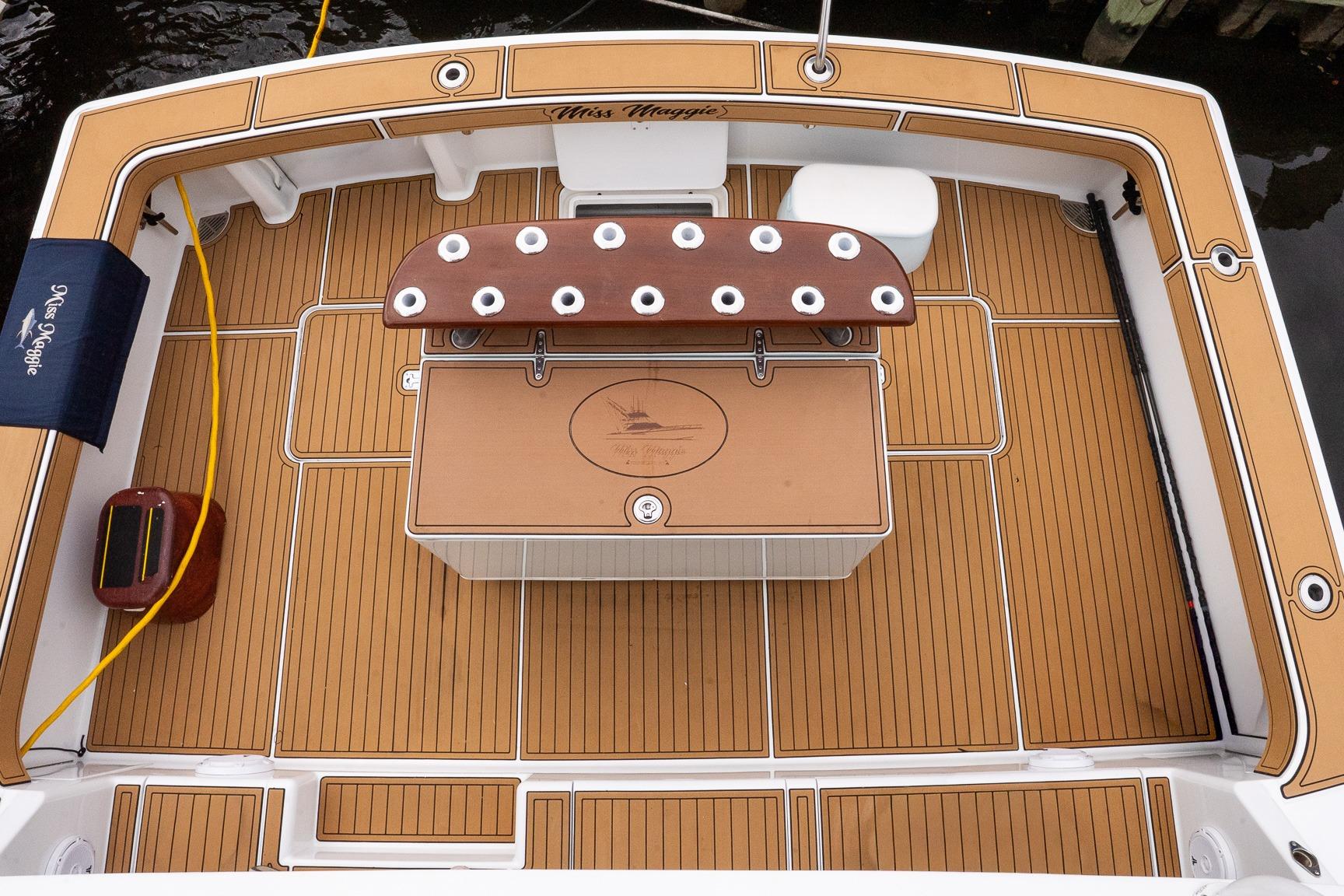 2002 Viking 61 Enclosed Bridge yacht deck with teak flooring and fishing rod holders.