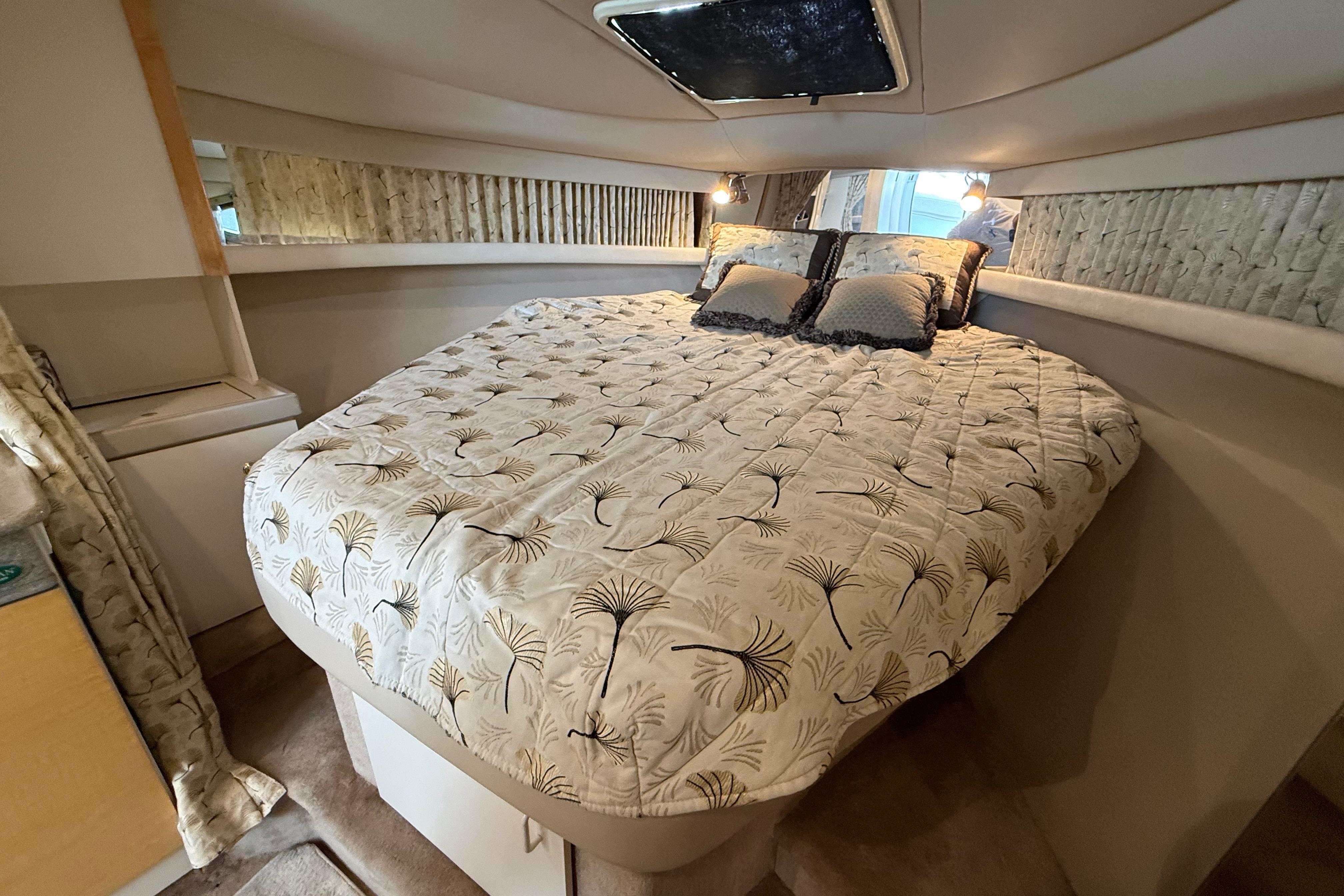 1999 Formula 34 Performance Cruiser cabin with cozy bed and elegant decor.