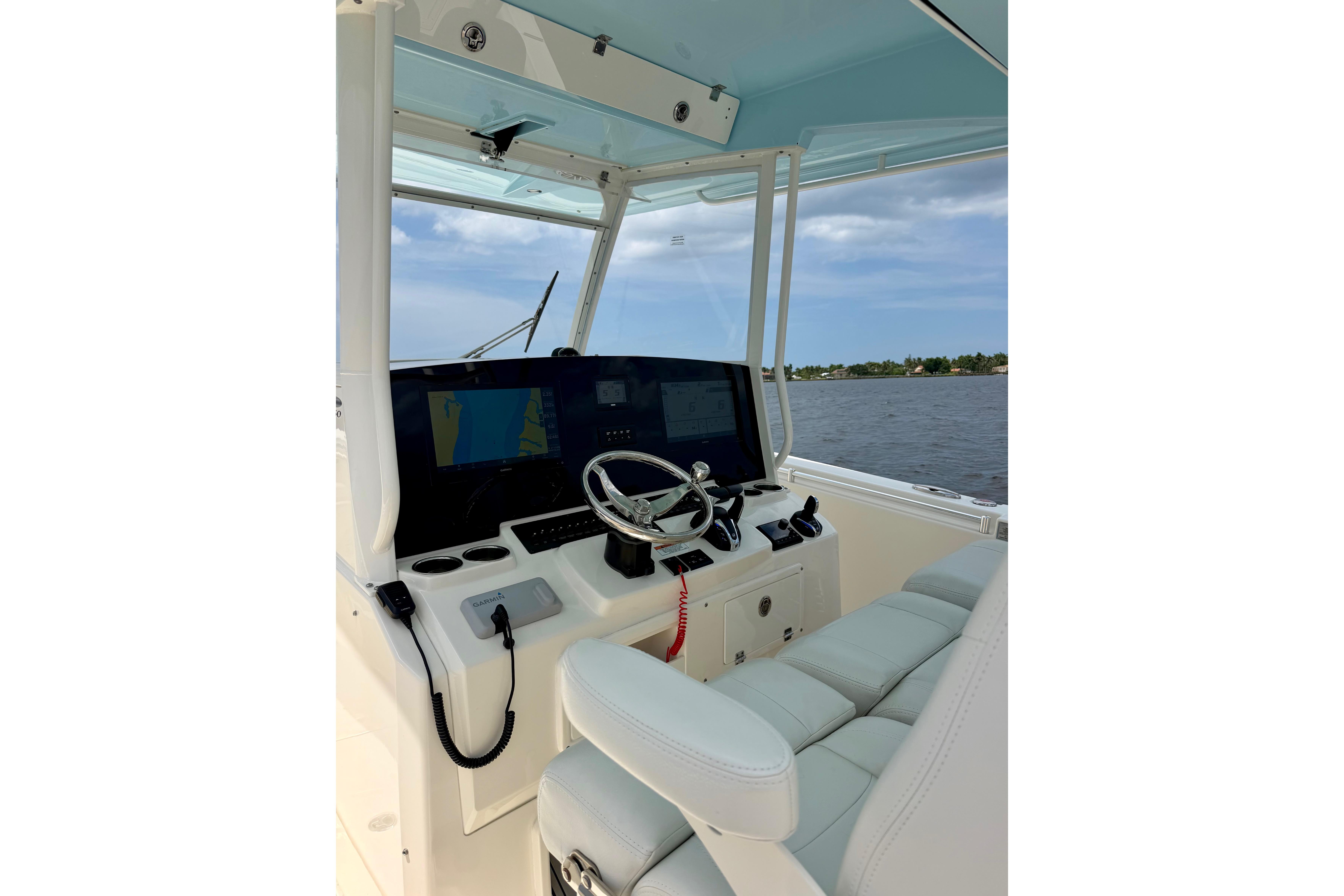 2023 Cobia 350 Center Console helm with modern controls and scenic water view.