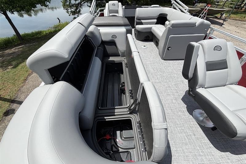2026 Sun Tracker SportFish 20 DLX pontoon boat interior with gray seating and storage compartments.
