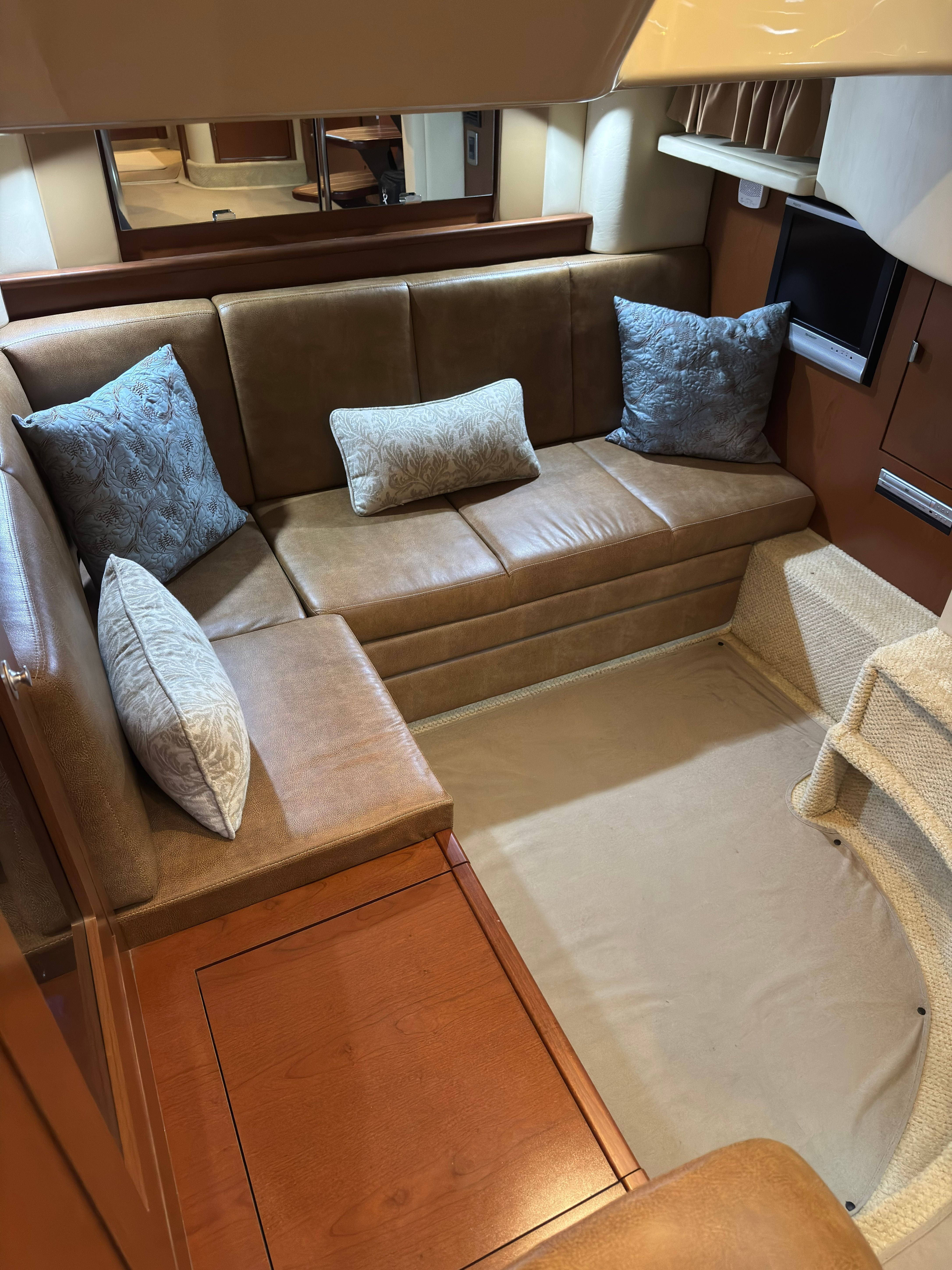 Interior of a 2007 Sea Ray 40 Sundancer with leather sofa and cushions.