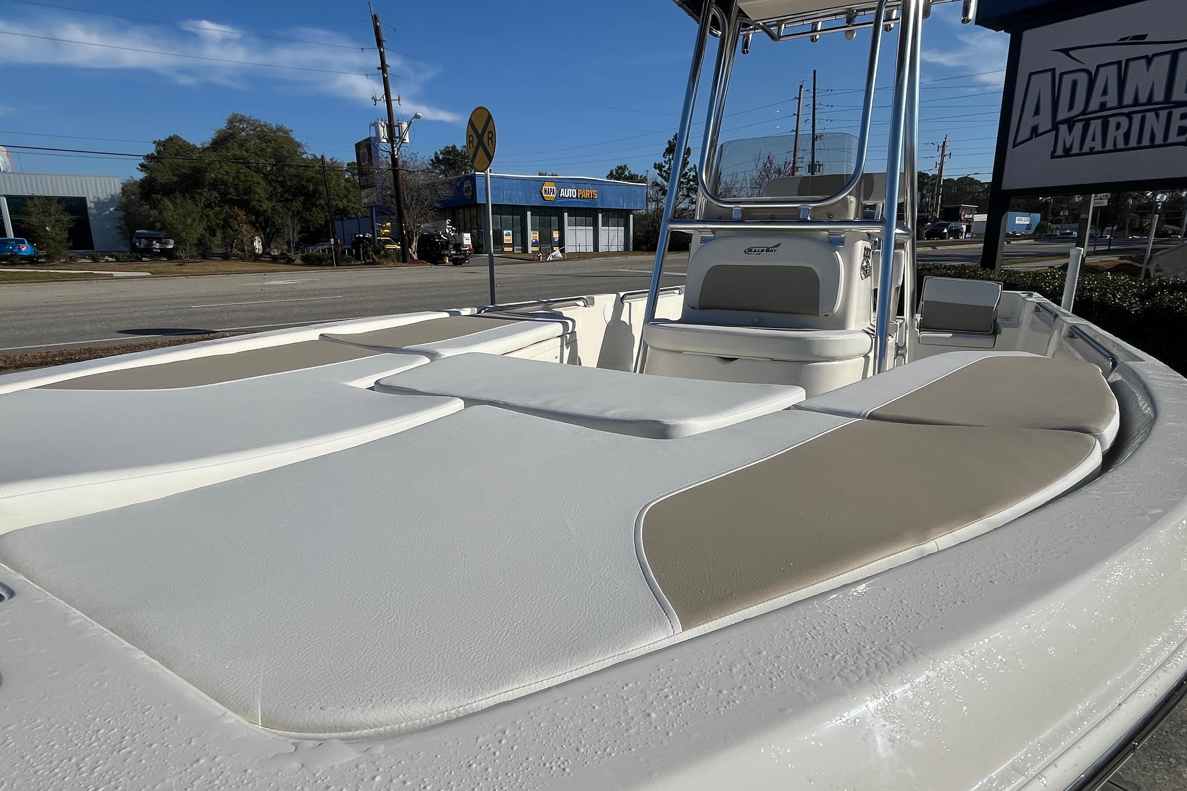 2026 Bulls Bay 2200 boat with cushioned seating, displayed at Adam's Marine dealership.