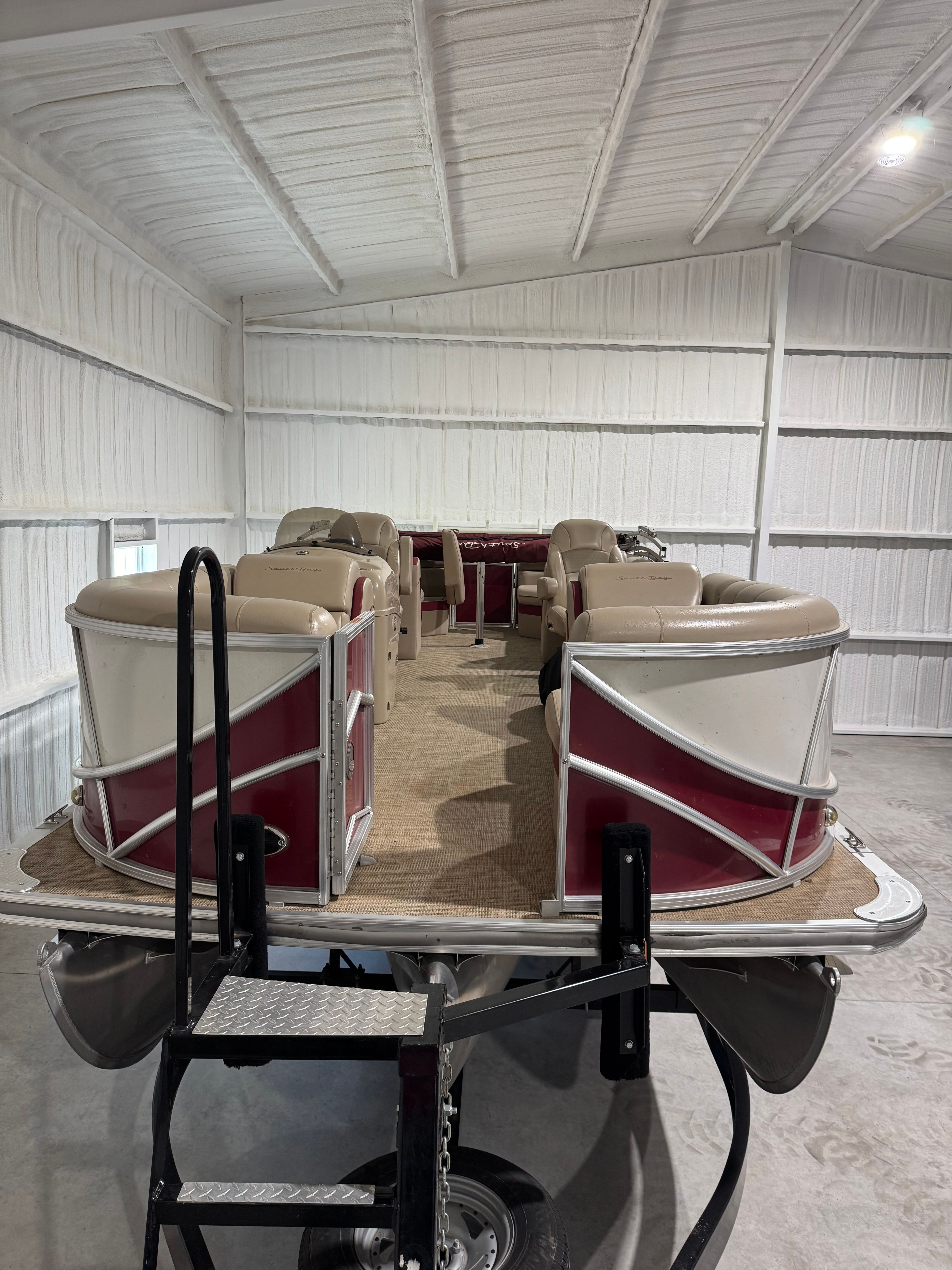 Custom 523 RS pontoon boat from 2016 in a storage facility.
