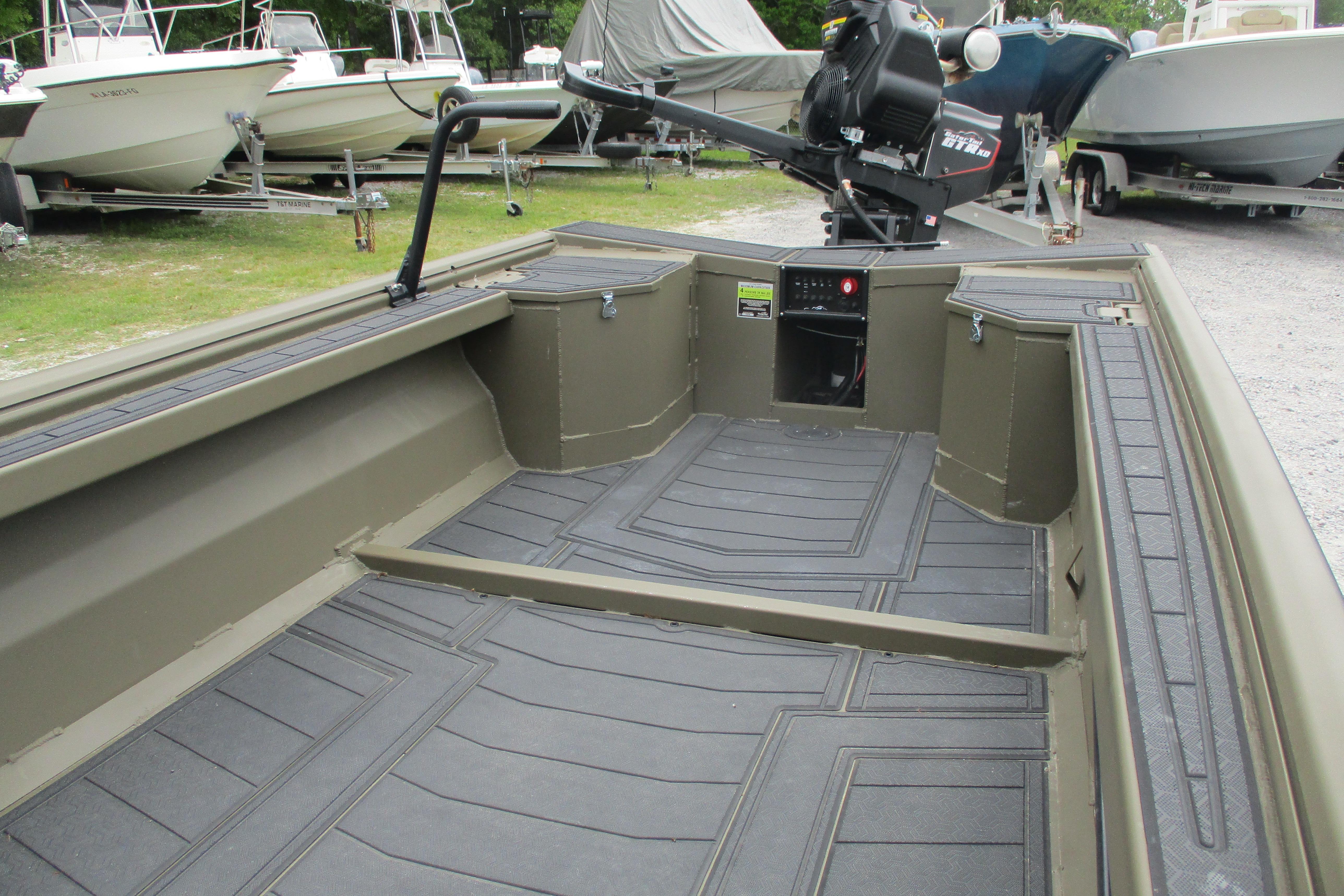 2026 Gator Tail 1854 Extreme boat interior with durable flooring and motor, parked among other boats.