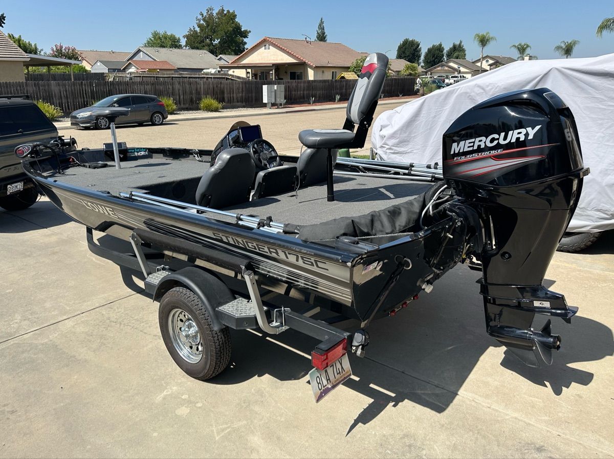 2018 Lowe Stinger 175C on a trailer in a residential area.