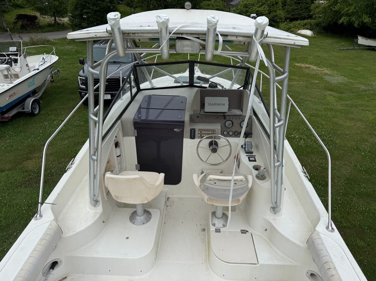 The image shows the cockpit of a 2001 Trophy 2509 Walkaround boat with two seats and a helm.