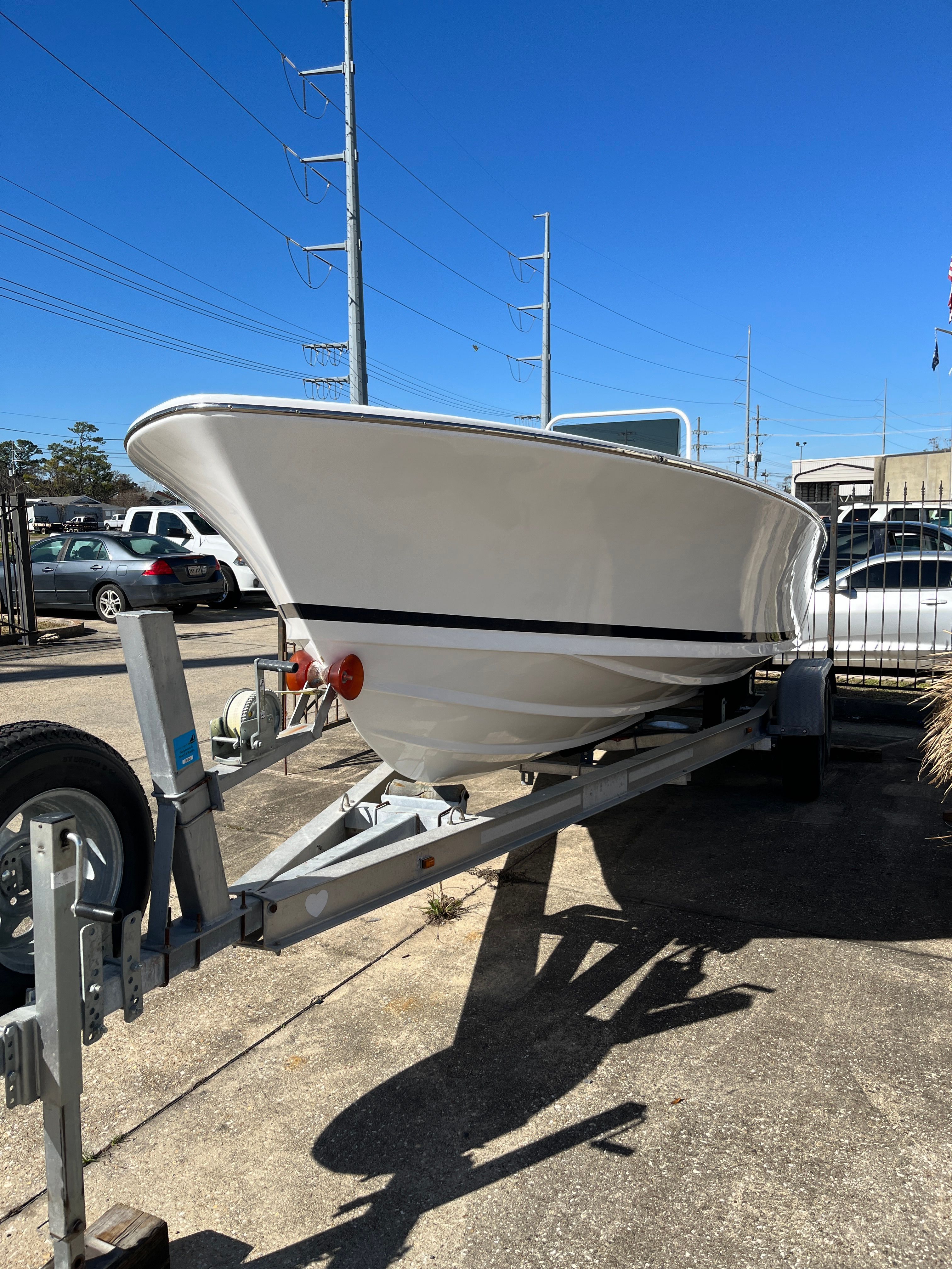 1970 Bertram Sportsman boat on trailer in sunny weather.