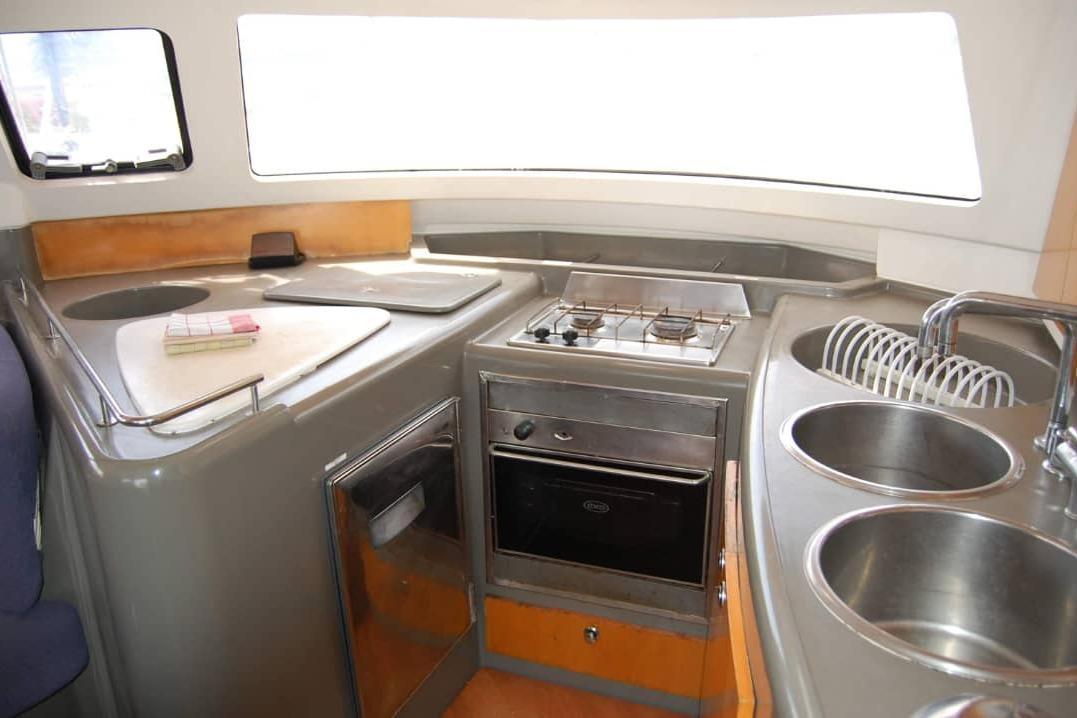 2006 Fountaine Pajot Belize 43 yacht kitchen with stove, sink, and modern amenities.