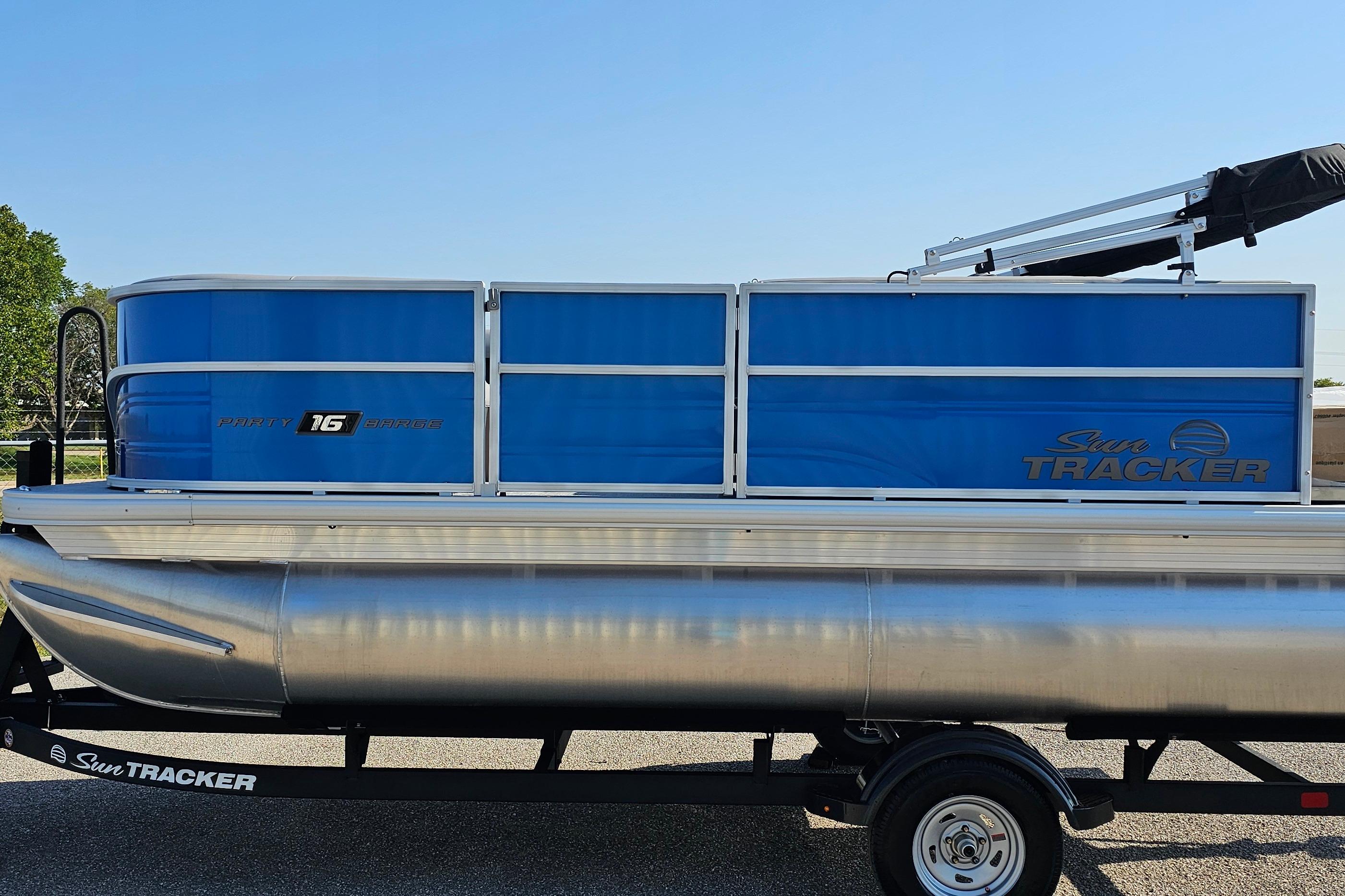 2026 Sun Tracker Party Barge 16 DLX pontoon boat on trailer, side view.