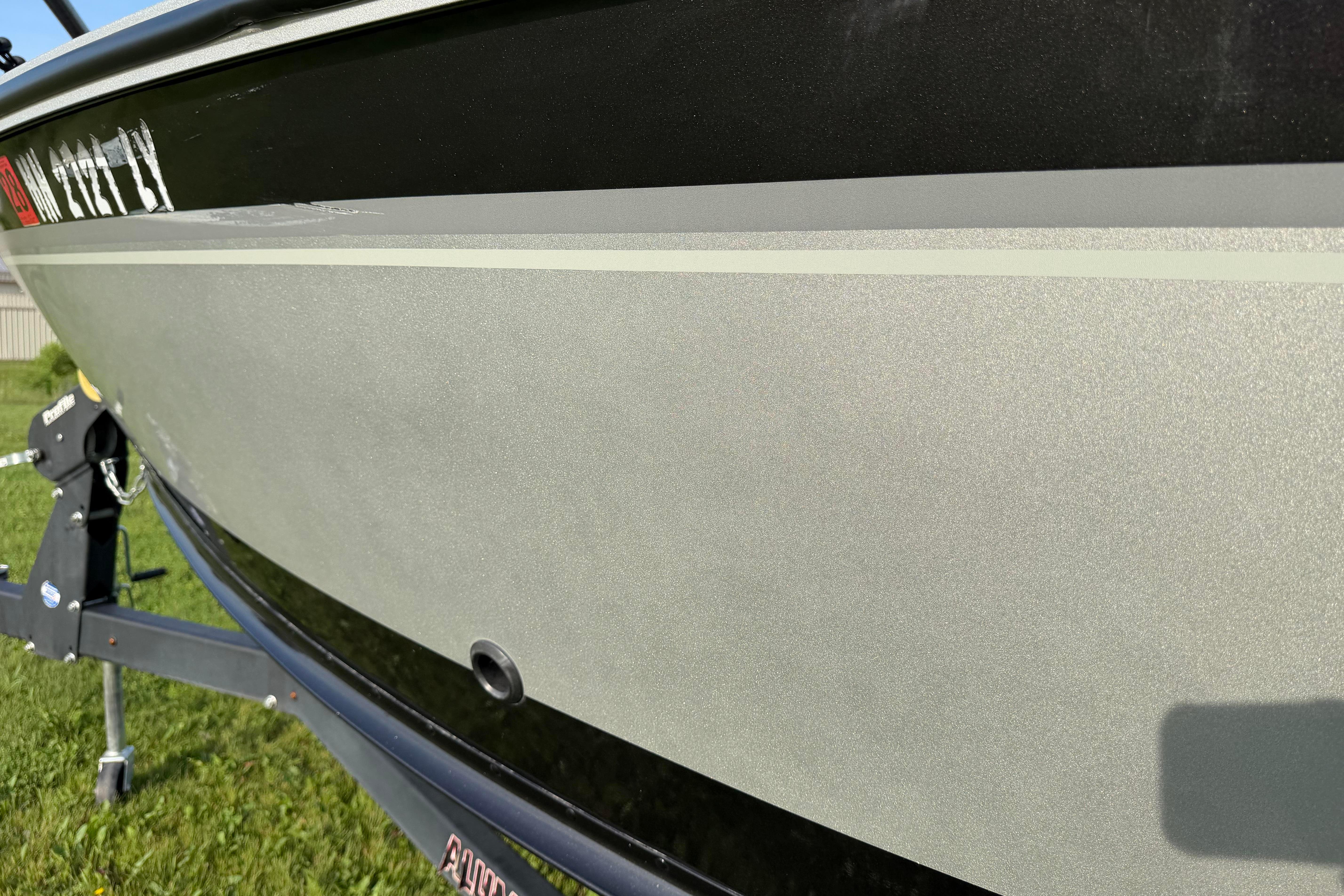 2019 Alumacraft Trophy 205 boat hull close-up, showcasing sleek design and metallic finish.